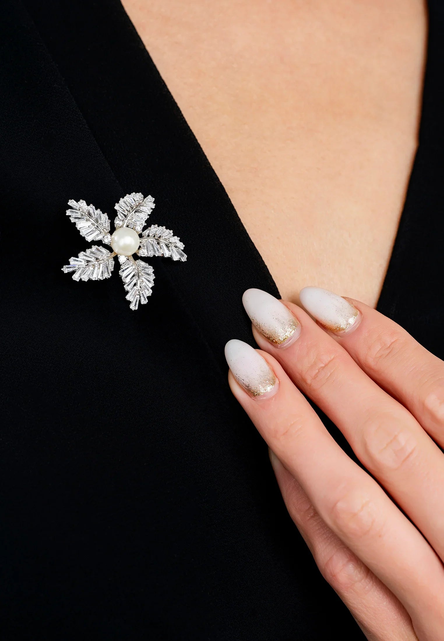 The brooch worn by a model.