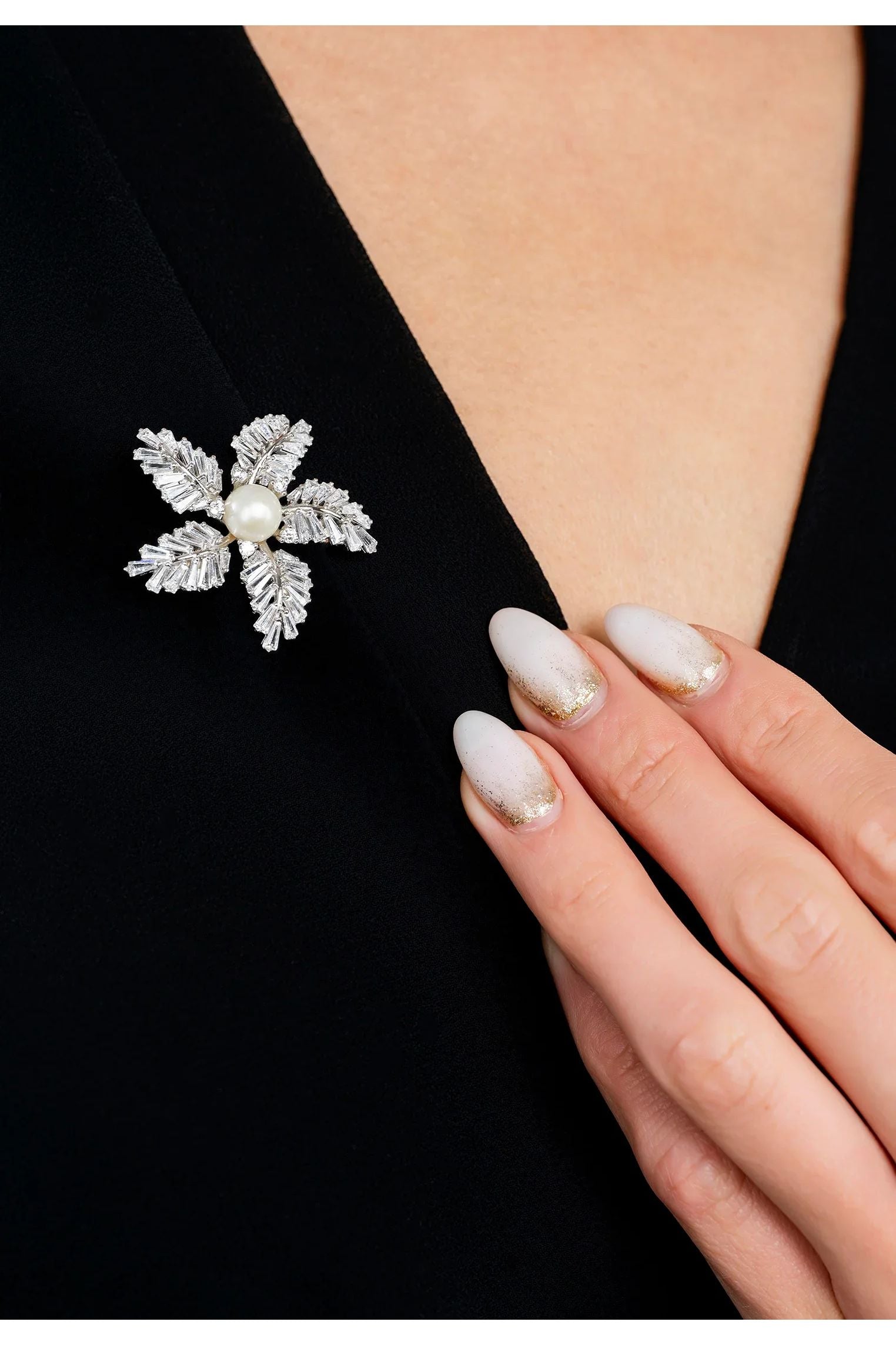 The brooch worn by a model.