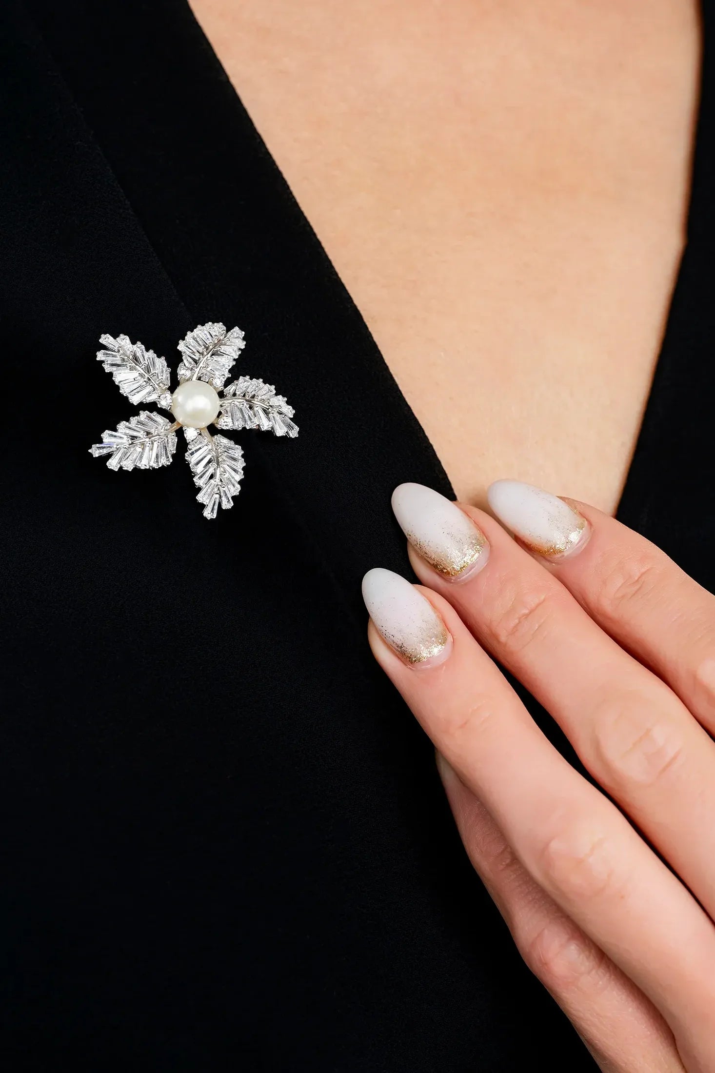 The brooch worn by a model.