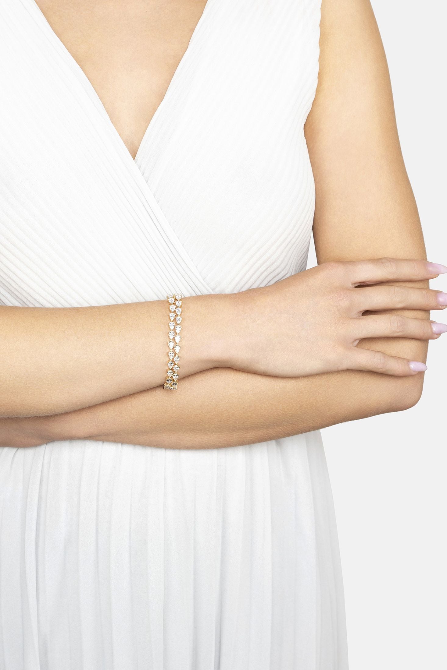 Woman wearing a pearl bracelet on a white background