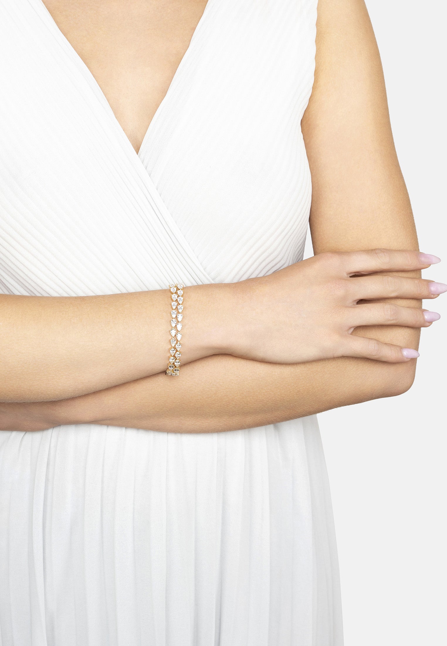 Woman wearing a pearl bracelet on a white background