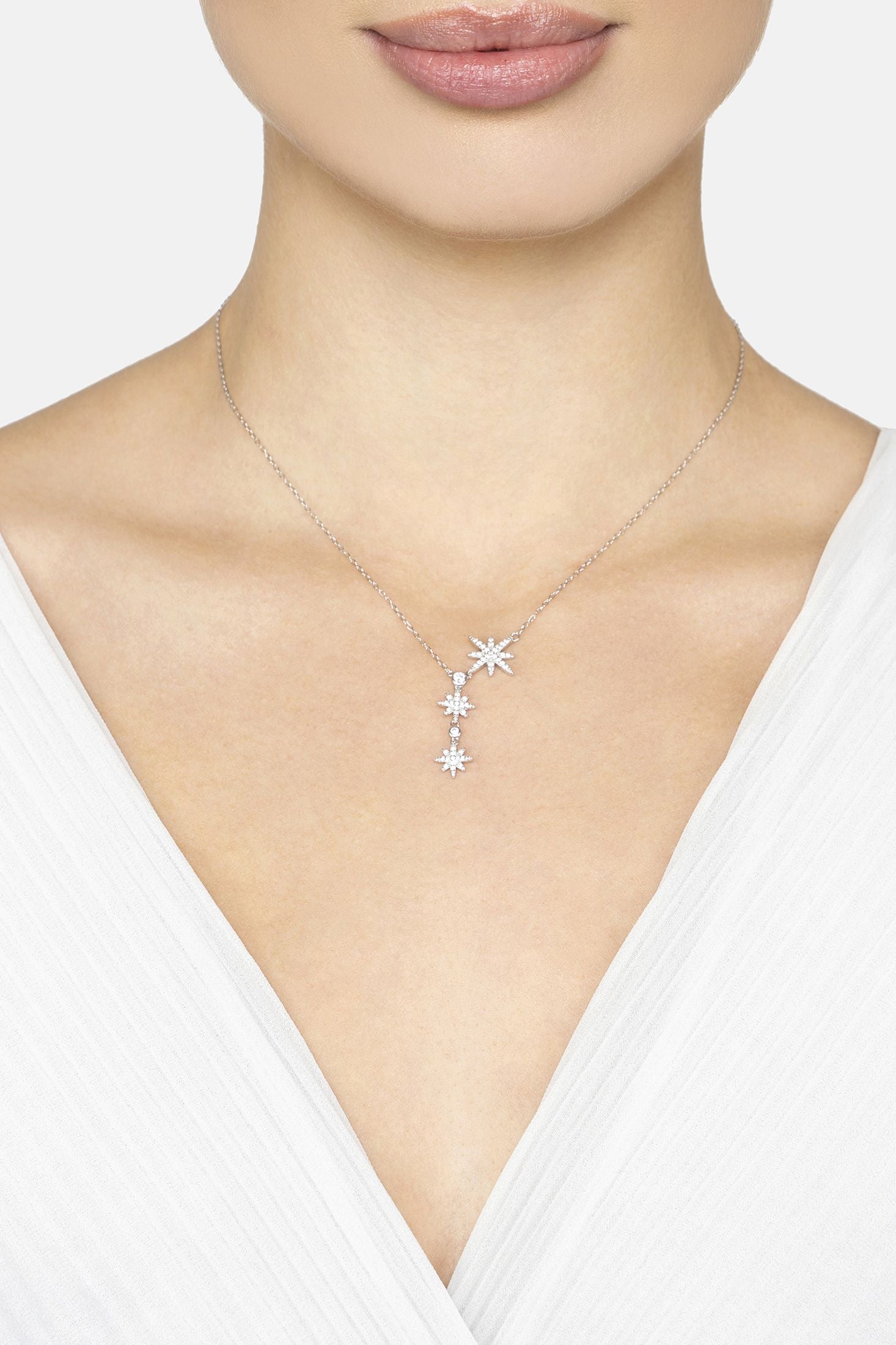 Necklace with star-shaped pendant worn by a model on a white background