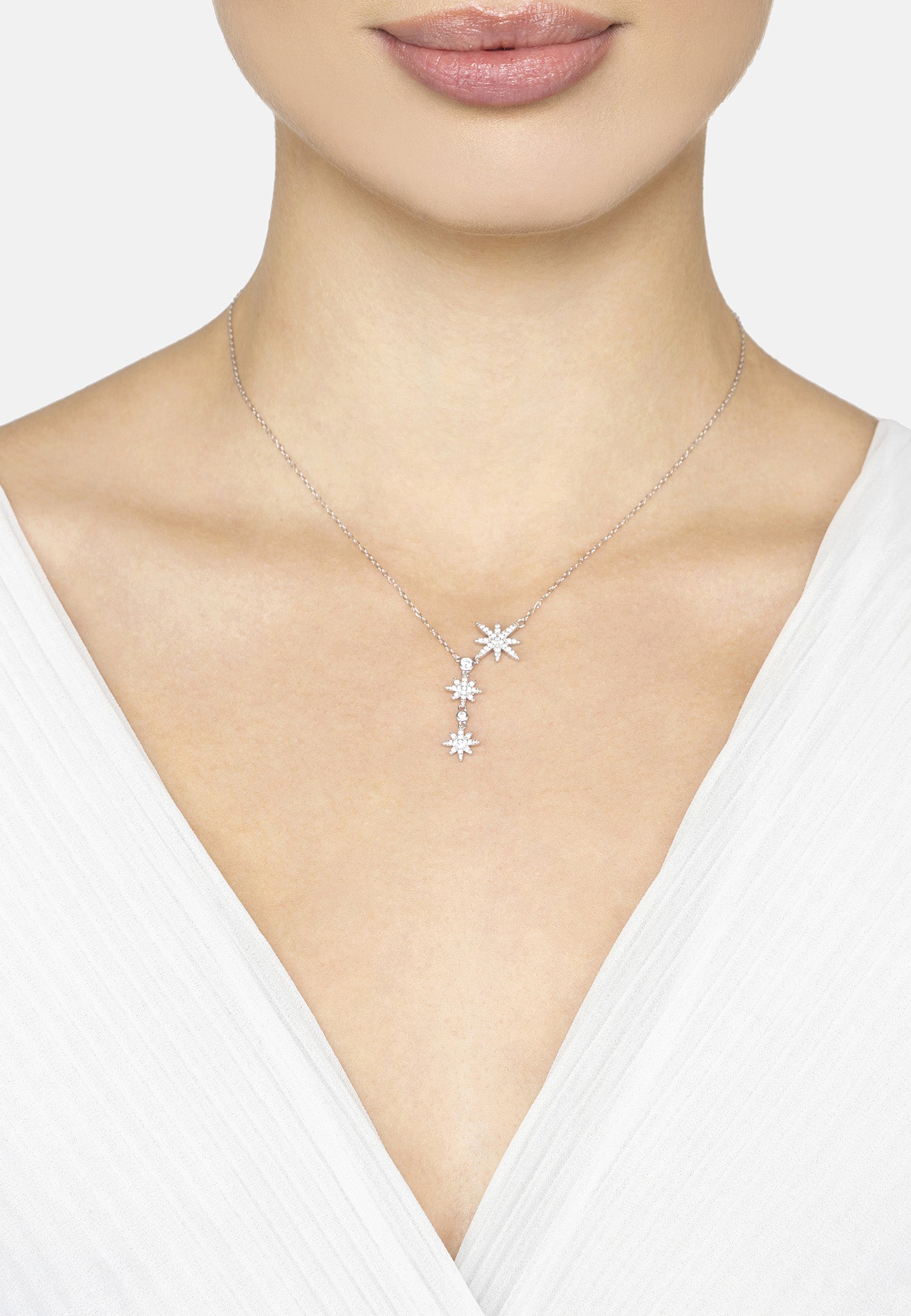 Necklace with star-shaped pendant worn by a model on a white background