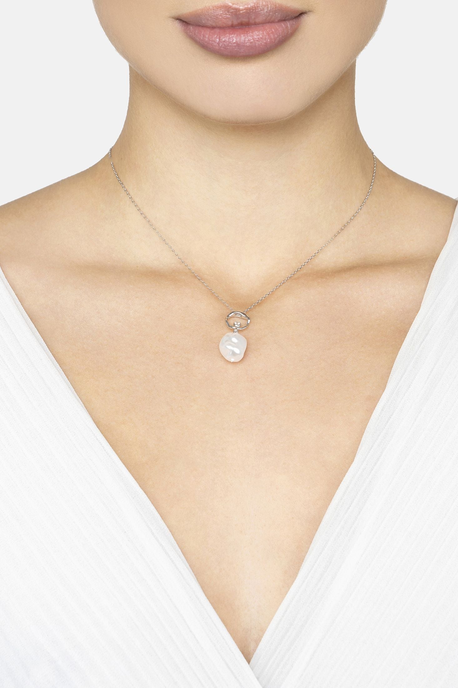 Necklace with a pendant worn by a person on a white background