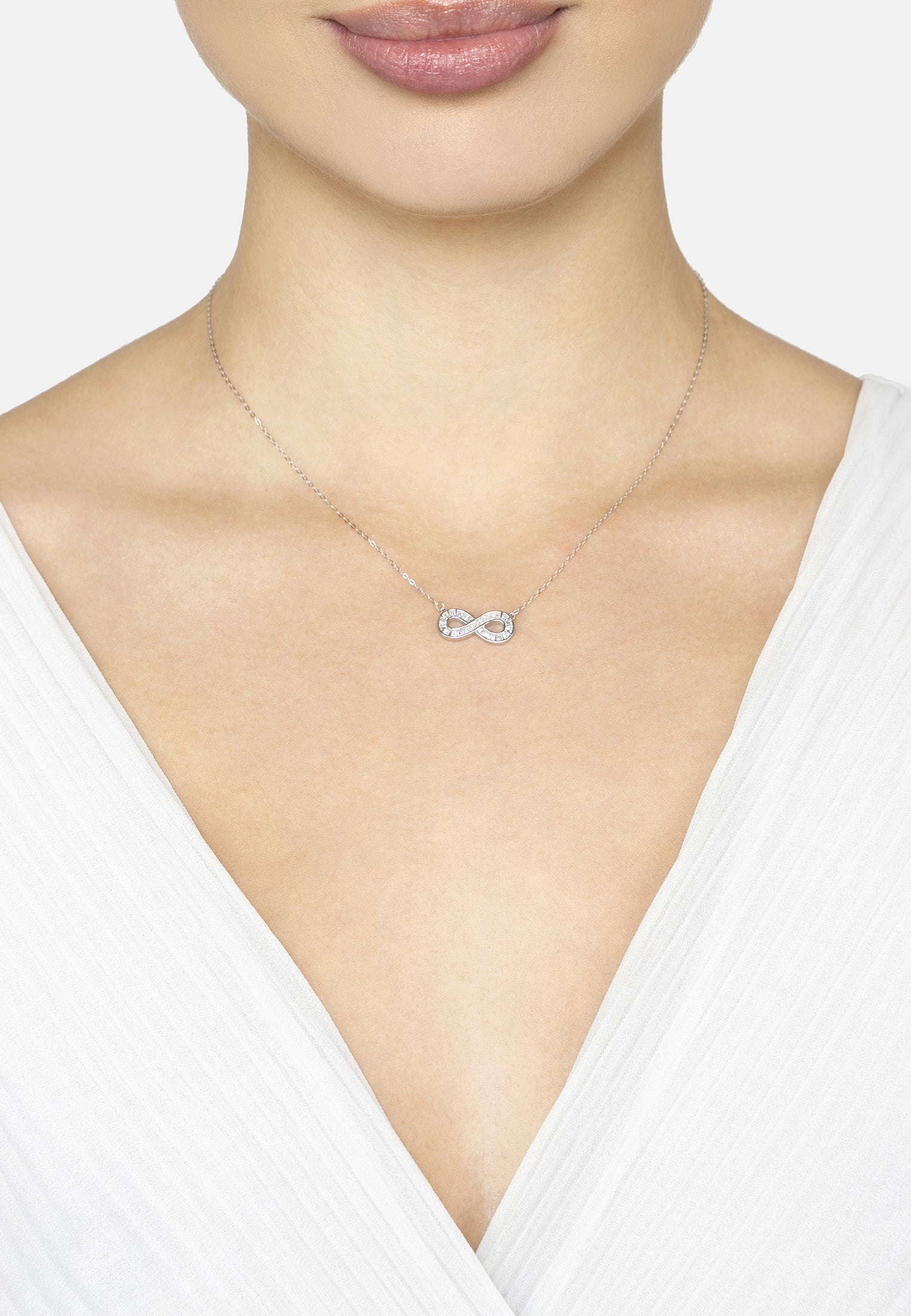 Necklace with a silver infinity pendant on a white background
