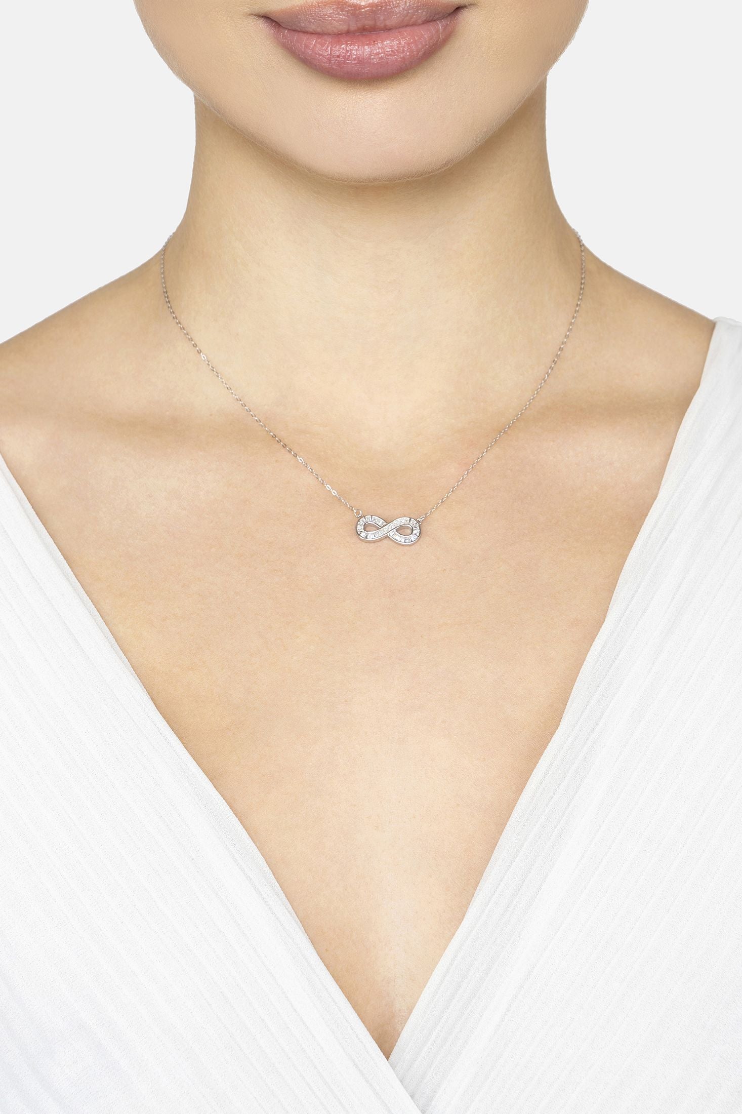 Necklace with a silver infinity pendant on a white background