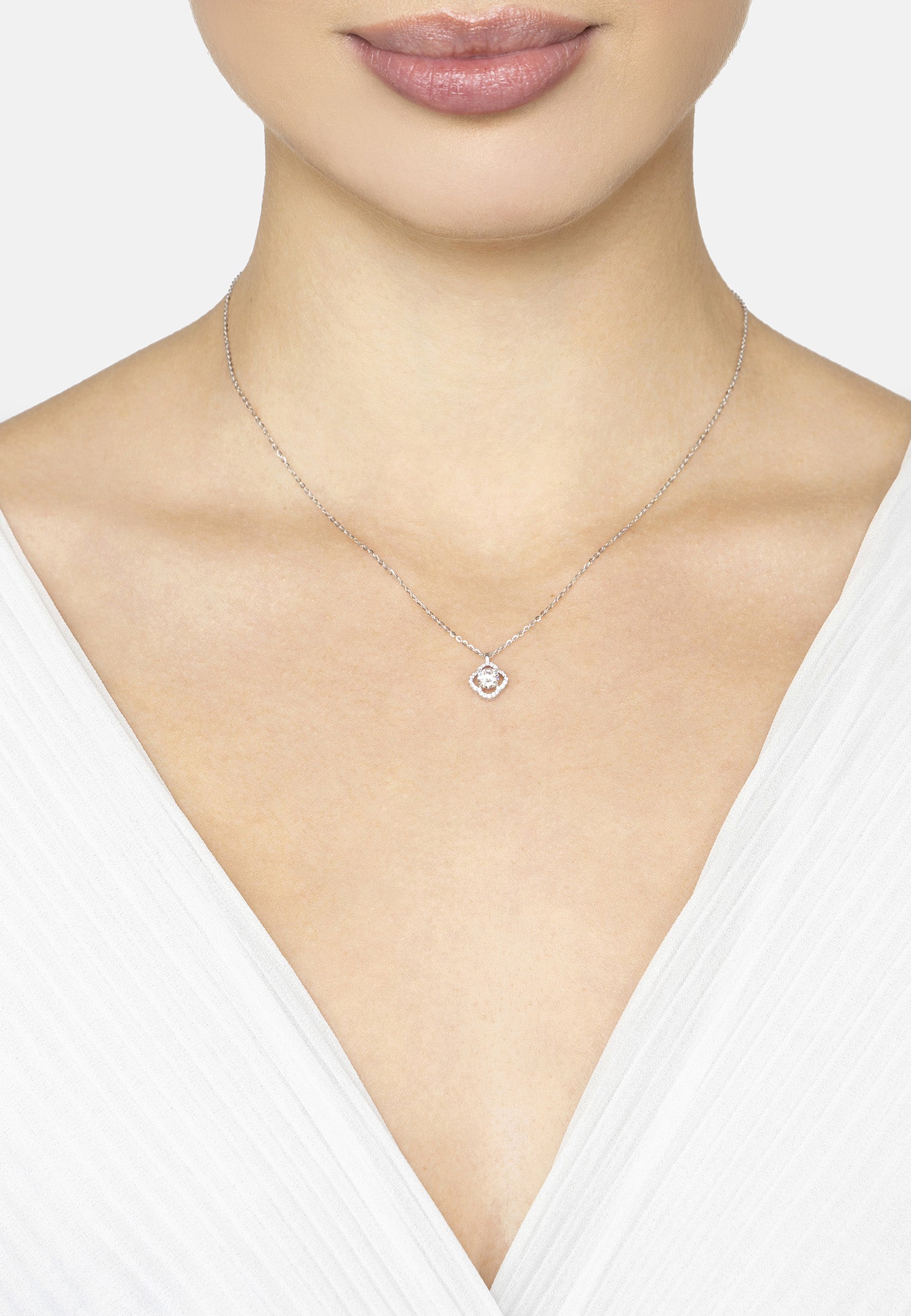 Necklace with a pendant worn by a person against a white background