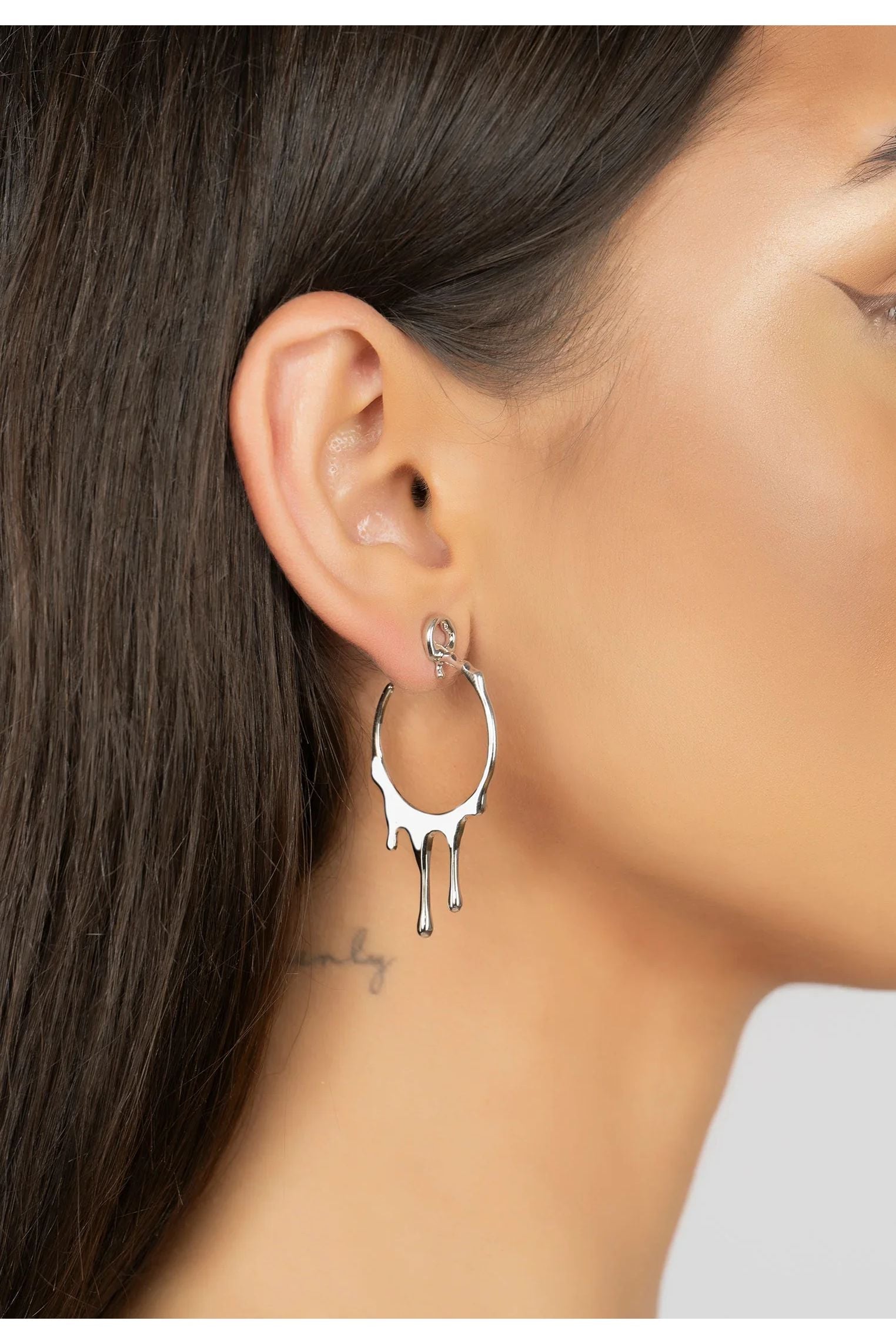 The earring worn by a model.