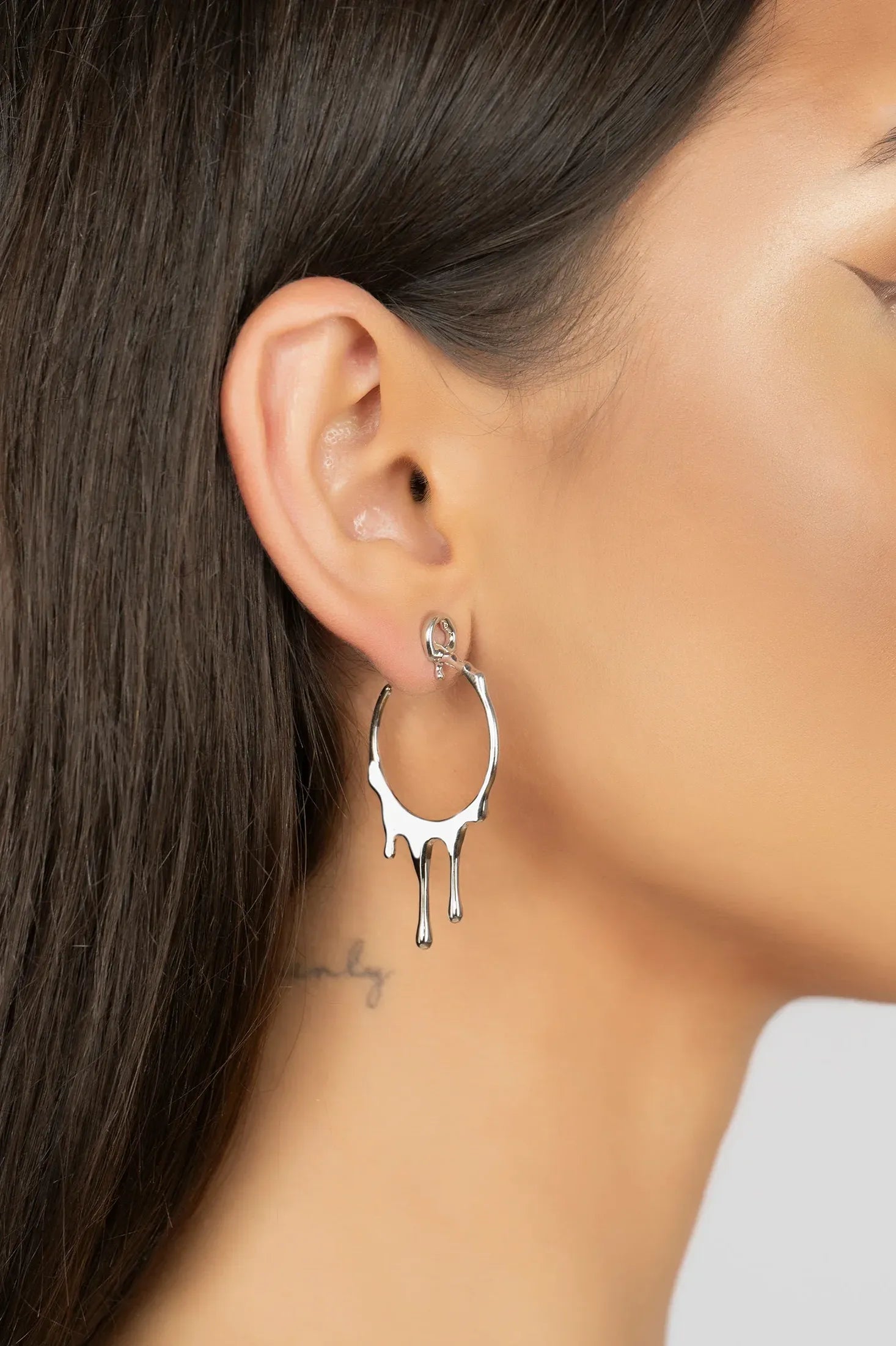 The earring worn by a model.