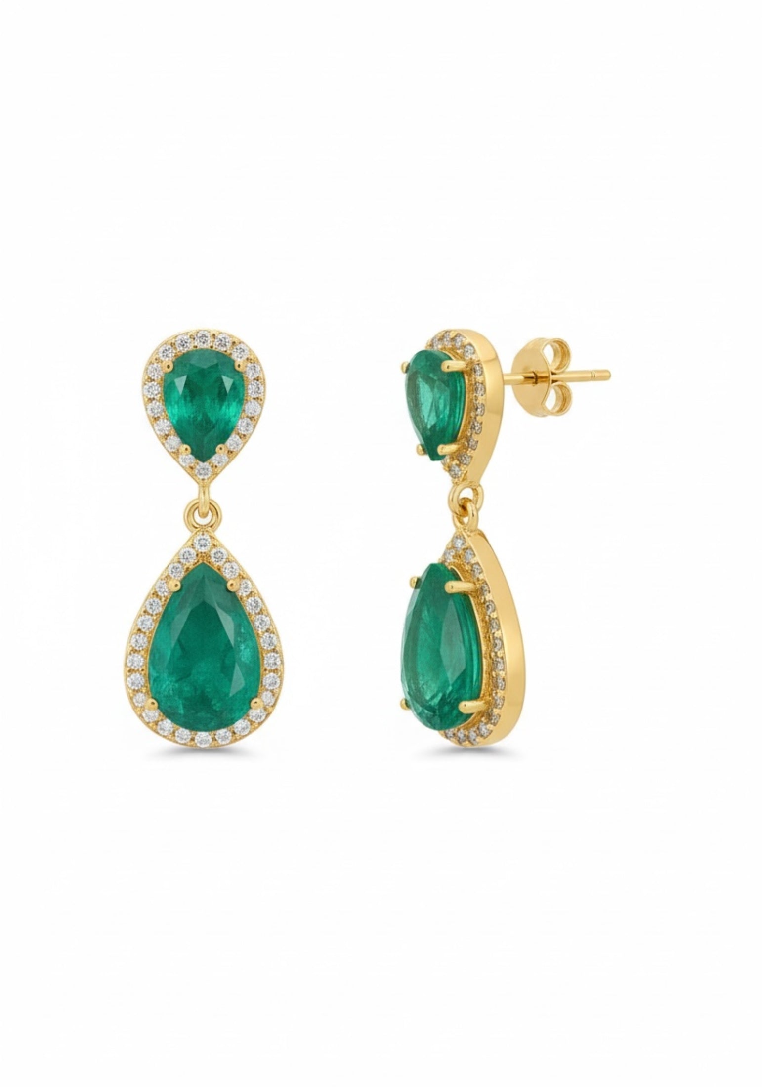 Gold earrings with green gemstones on a white background