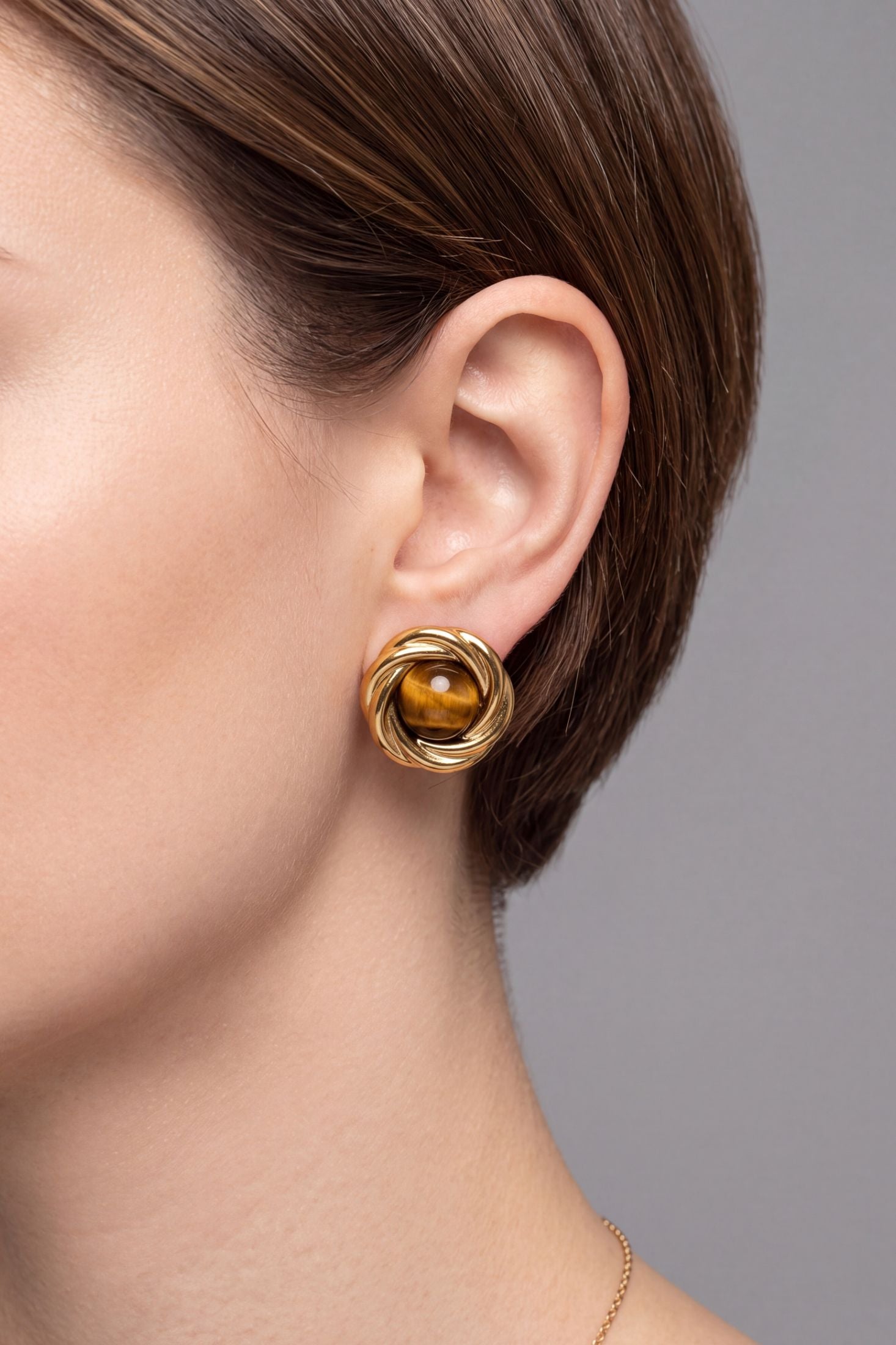 Angled view of Dynasty Tigers Eye Knot Stud Earrings Gold, showing gold finish and the jewellery profile.