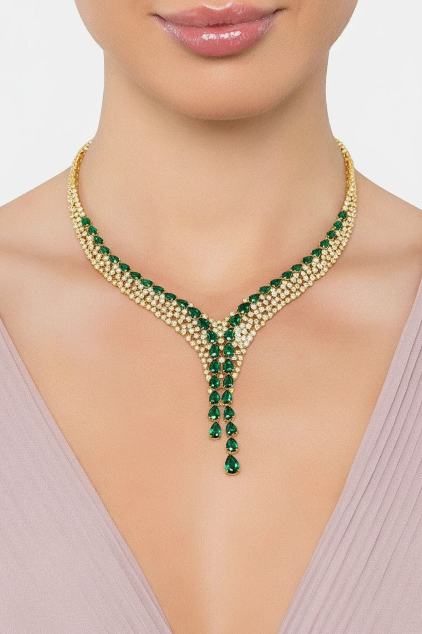 Gold statement necklace with green gemstones worn by a model.