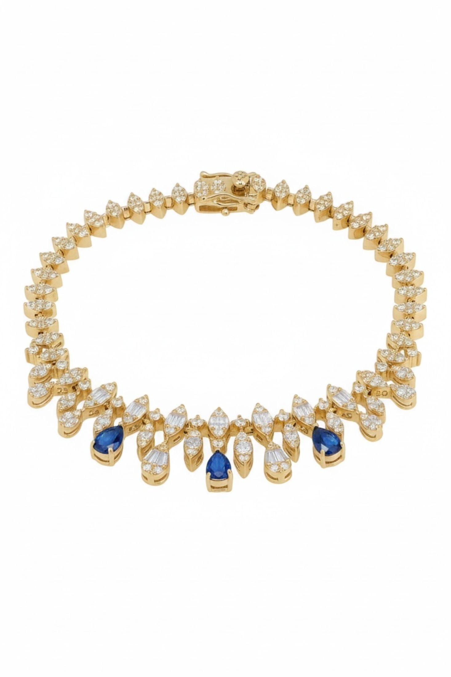Gold bracelet with blue and clear gemstones on a white background