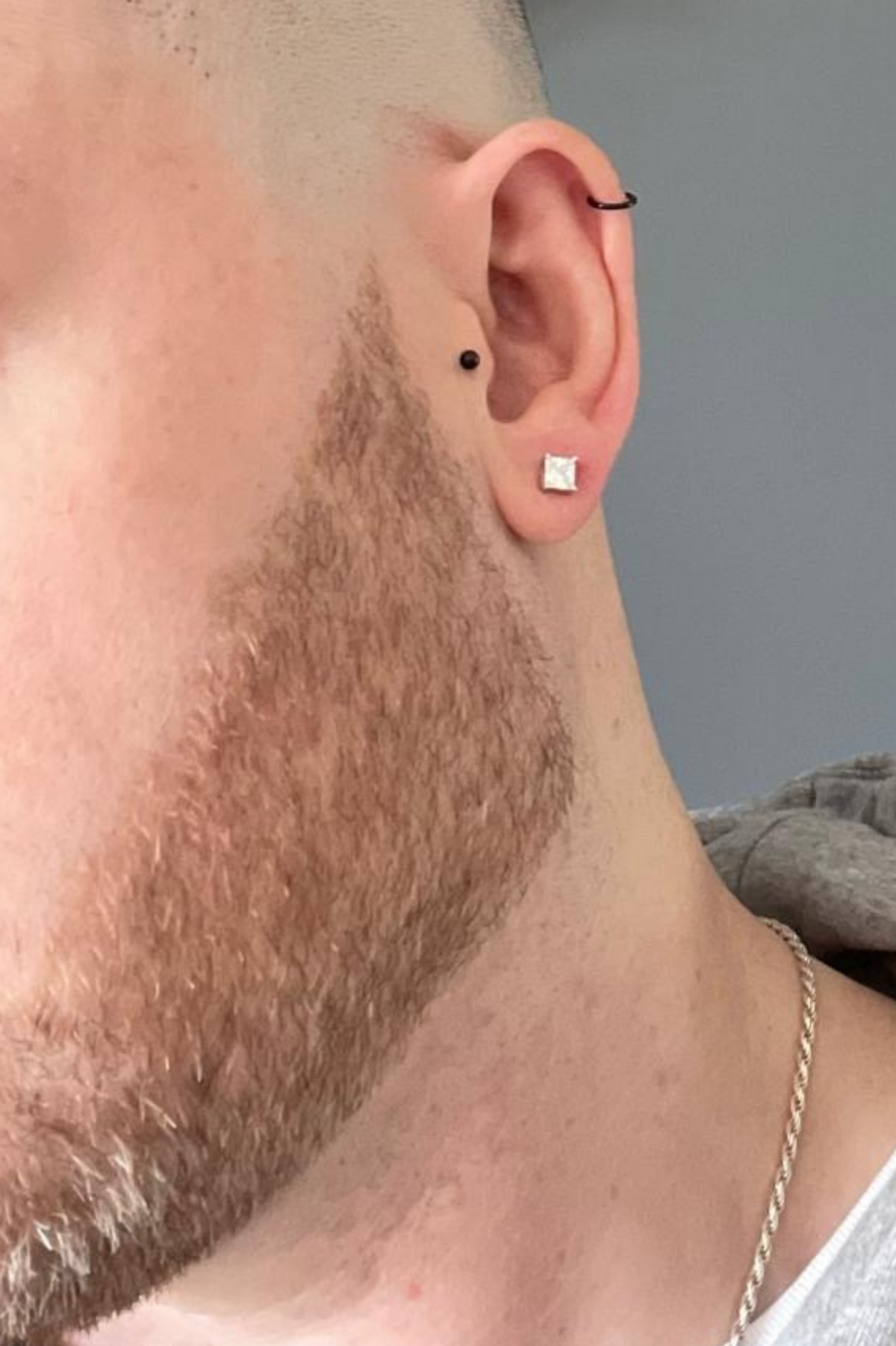 Angled view of Mens Single Square Solitaire Stud Earring Moissanite Silver, showing silver finish and the jewellery profile.