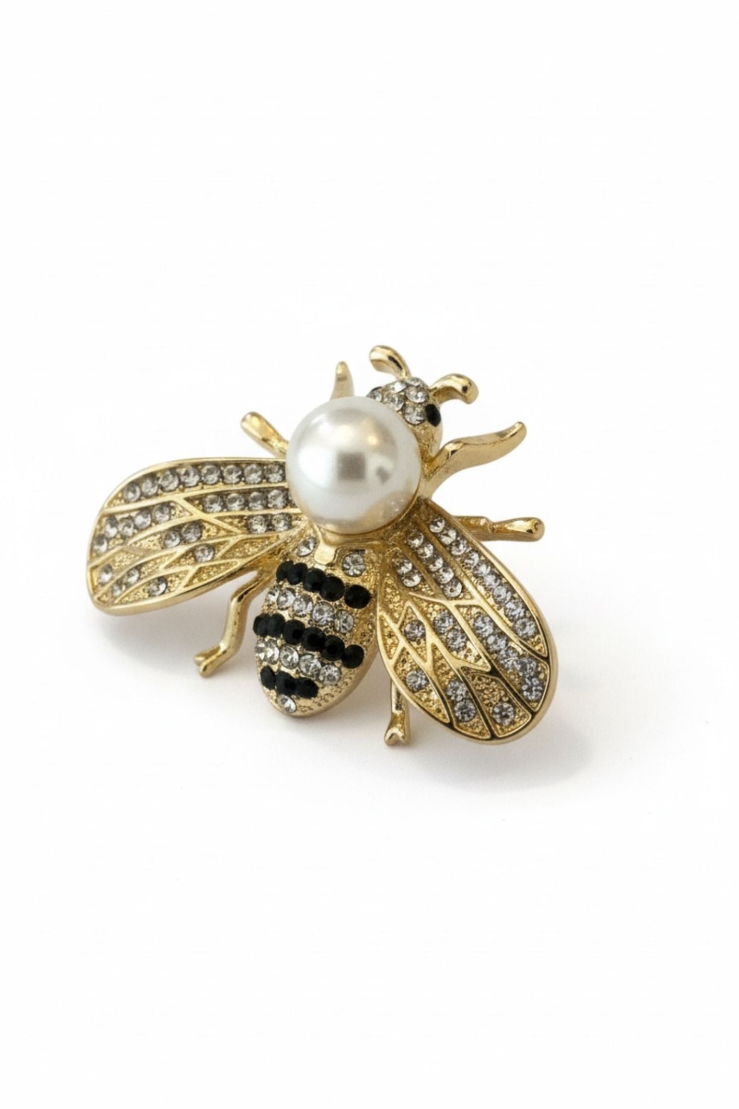 Gold bee-shaped brooch with a pearl body on a white background