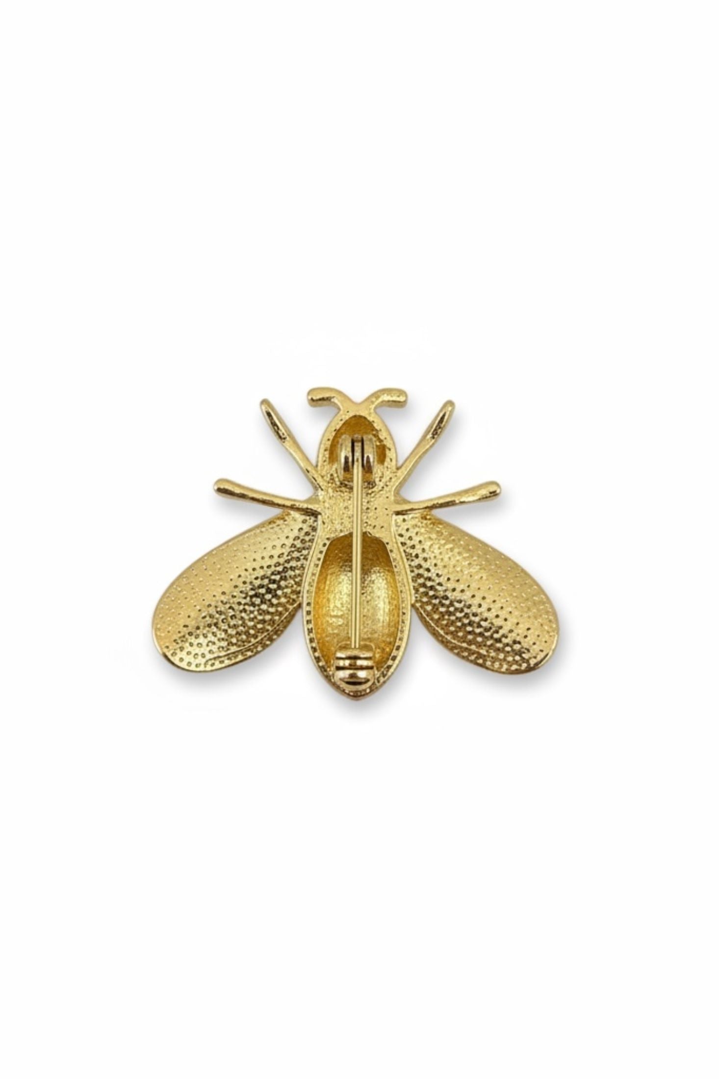 Gold bee shaped brooch on a white background