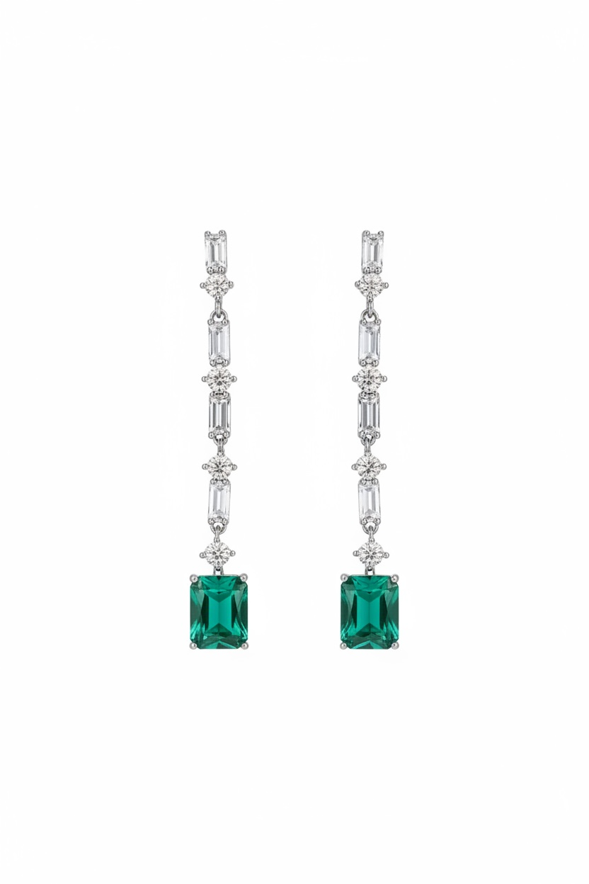 Pair of emerald green square gemstone earrings with diamond-studded silver hooks on a white background