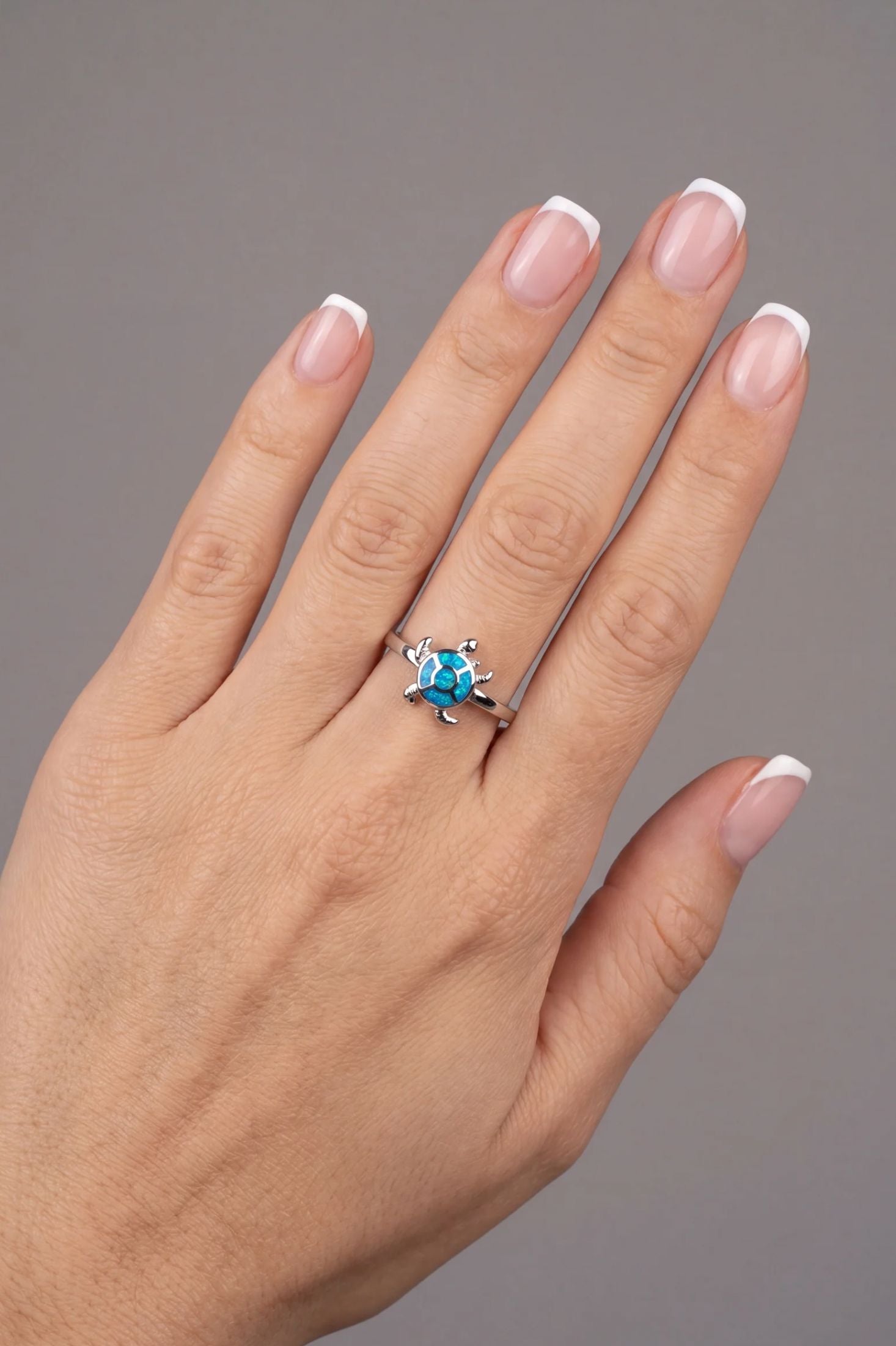 Angled view of Turtle Blue Opalite Ring Silver, showing turtle design, opalite detailing, silver finish and the jewellery profile.