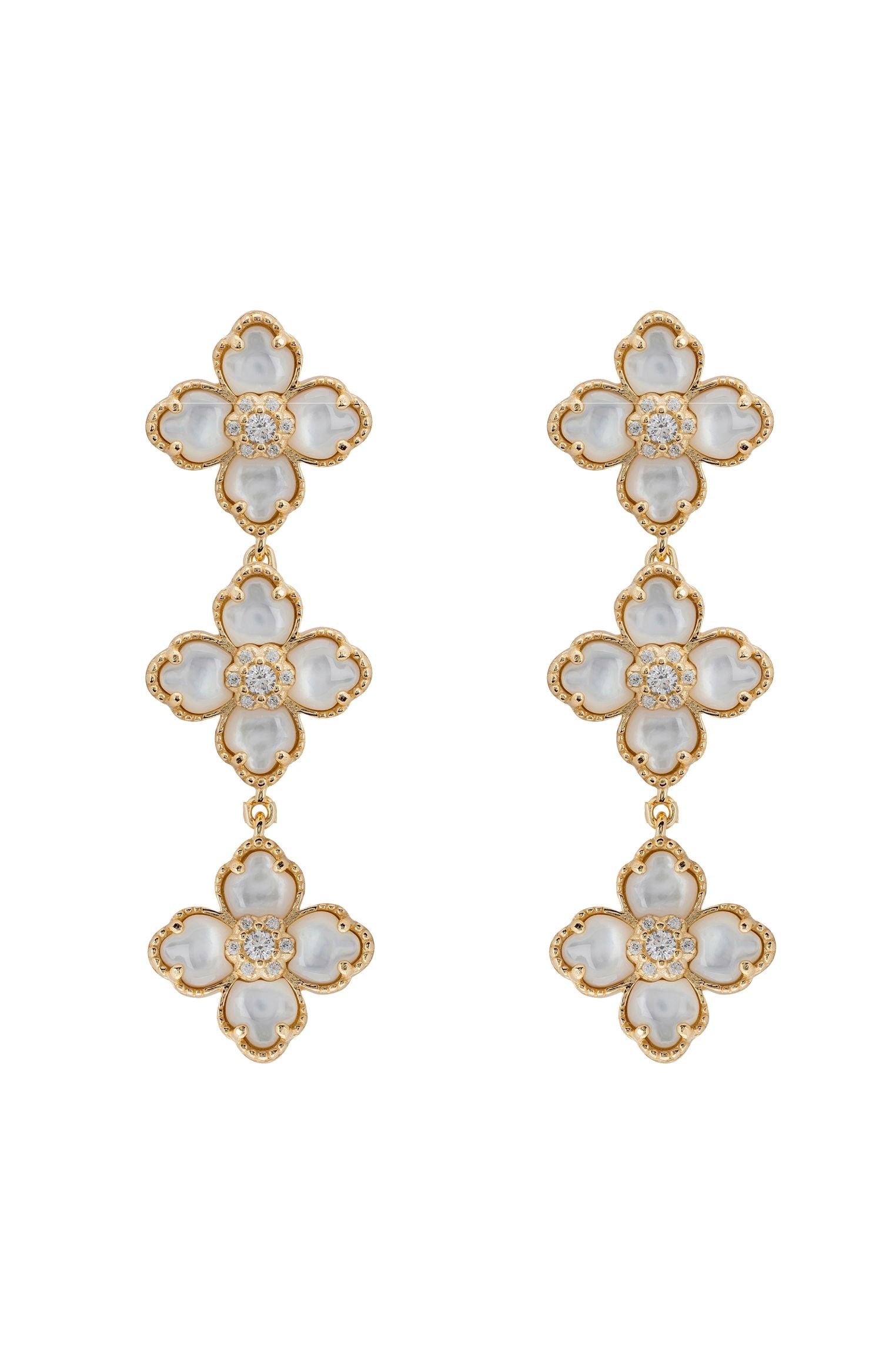 Gold and white floral earrings on a white background