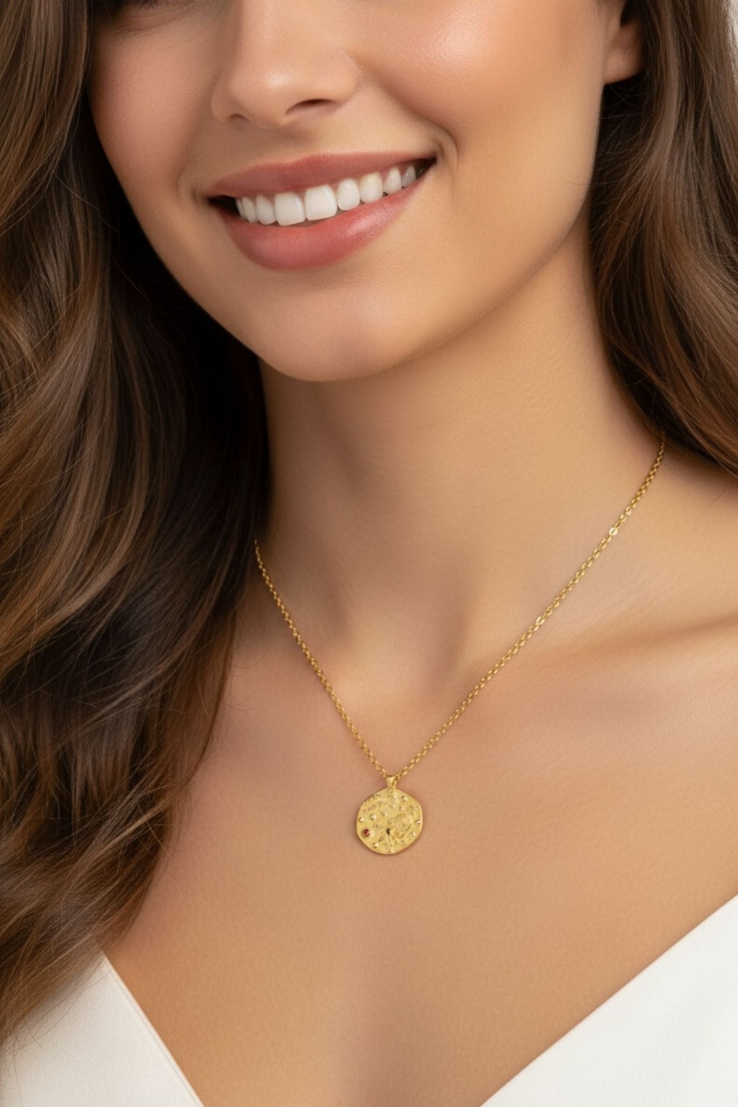 Close-up of a woman wearing a gold necklace with a pendant.