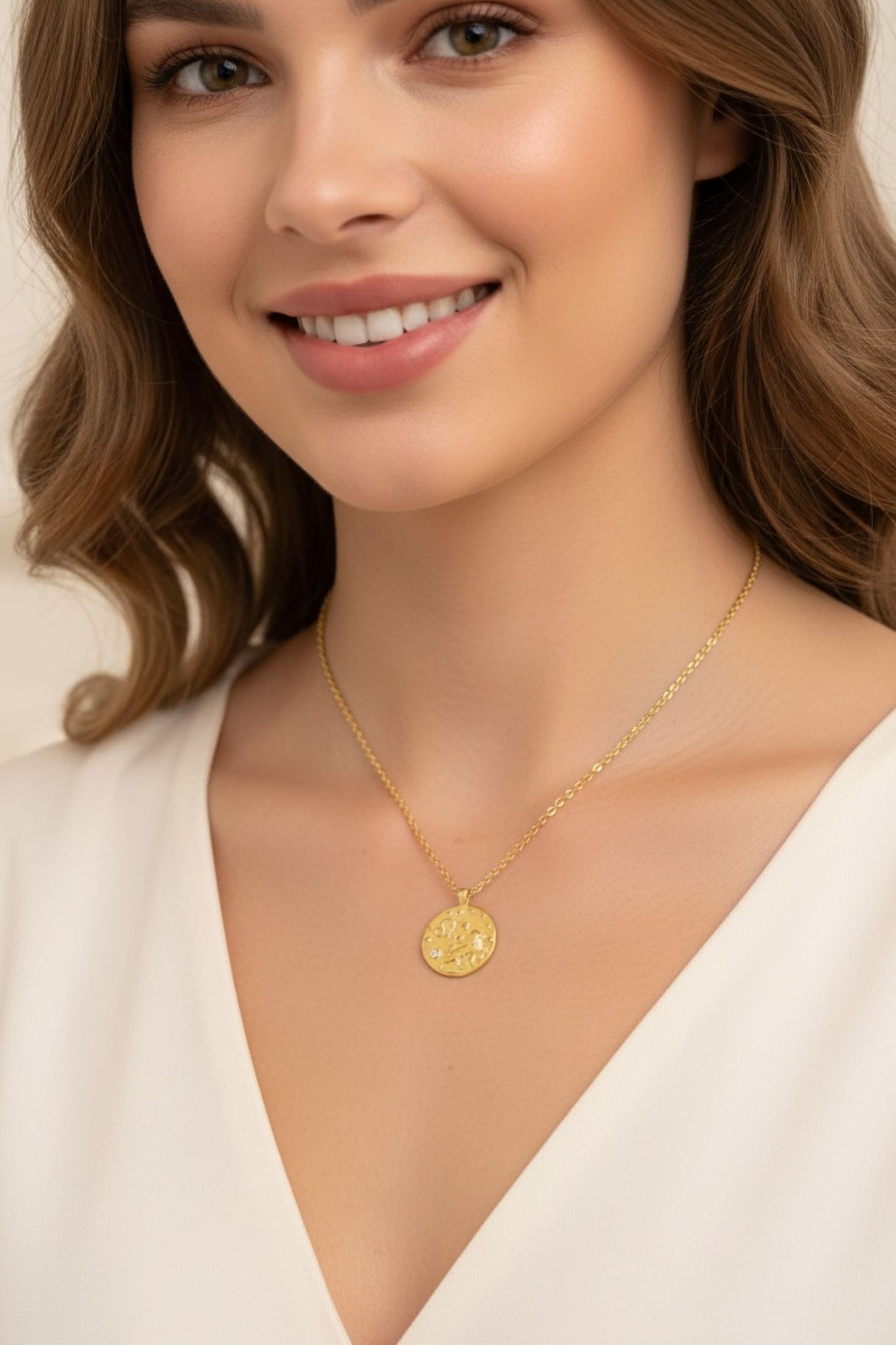 Gold pendant necklace worn by a model