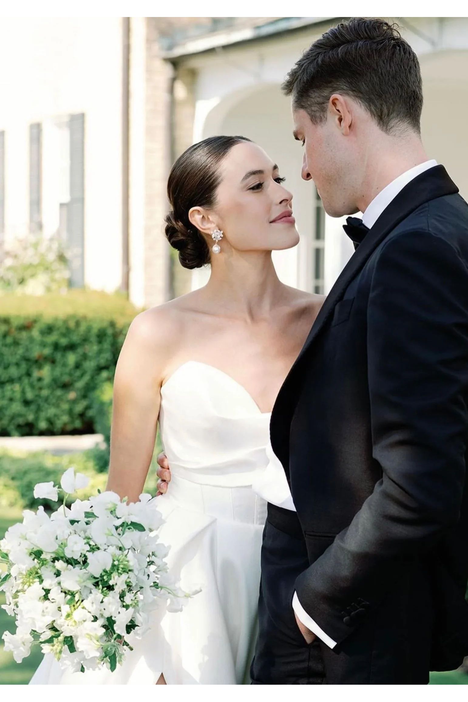 The earring worn by a bride posing with the groom.