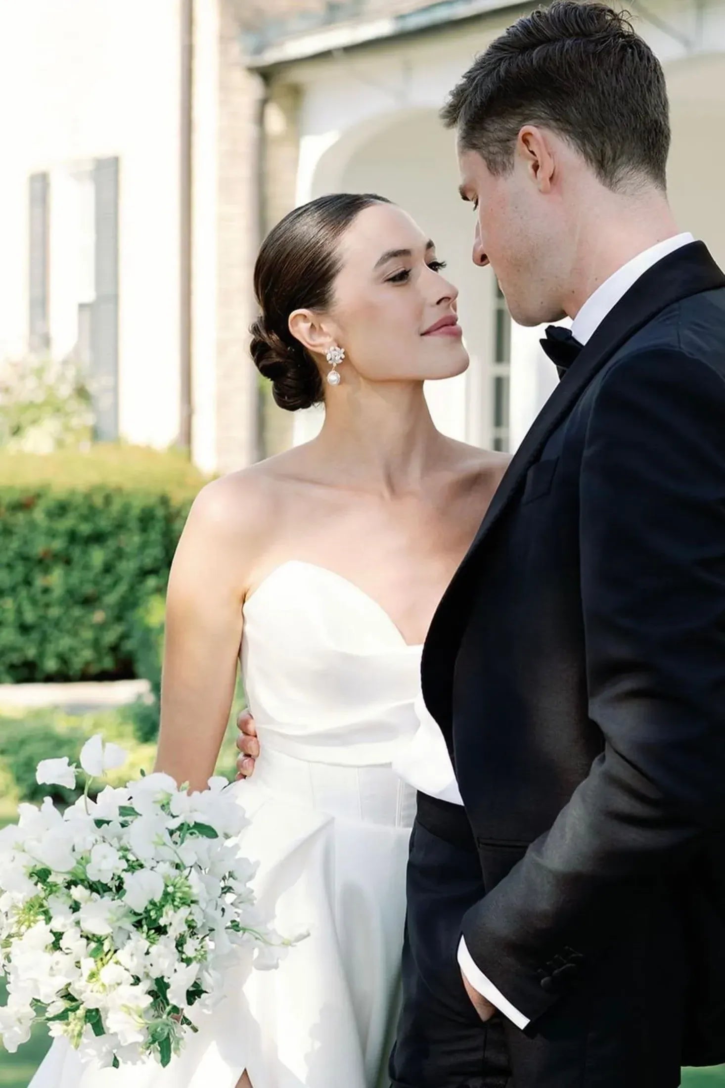The earring worn by a bride posing with the groom.