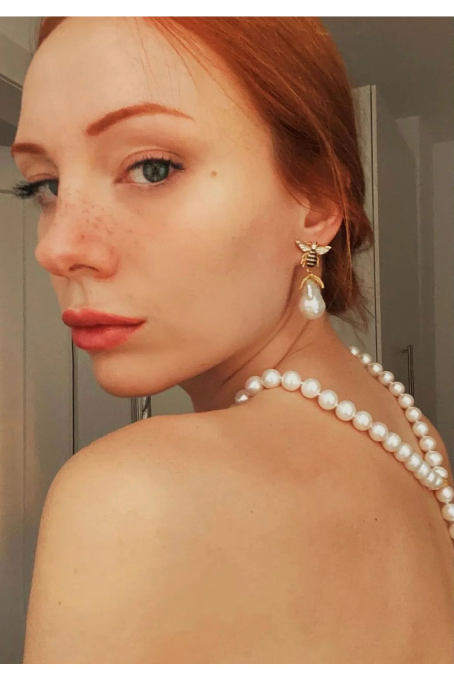 The earring worn by a model.