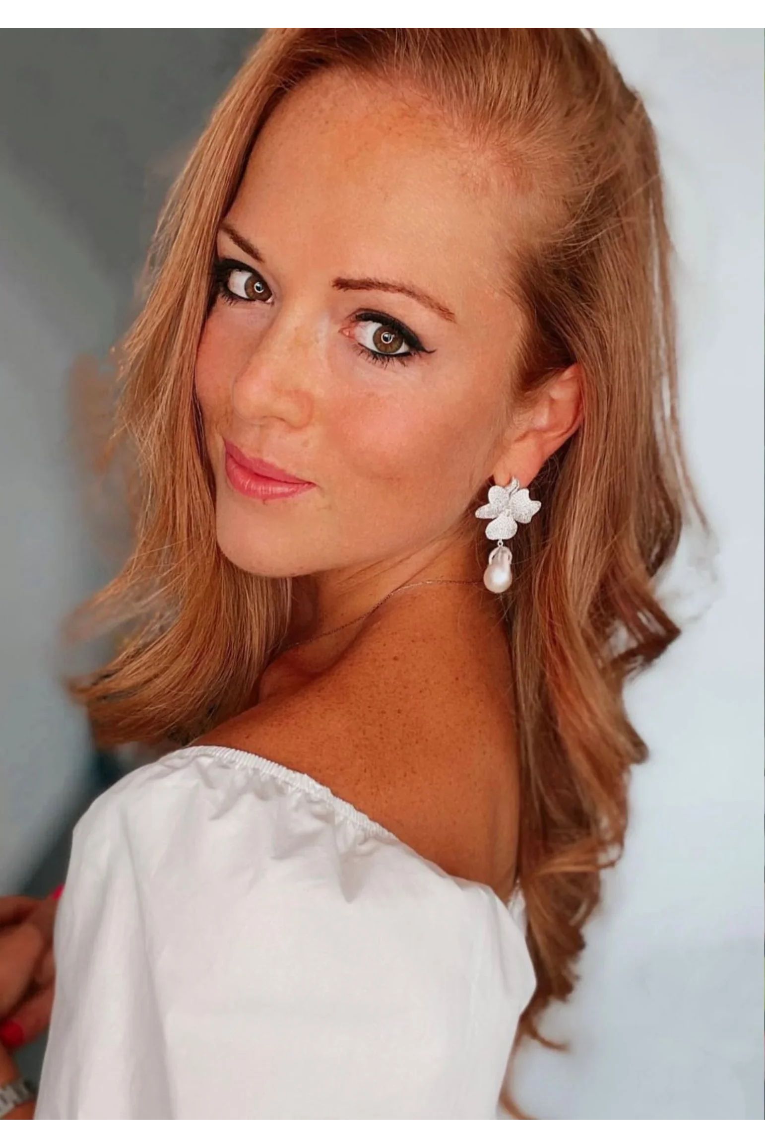 The earring worn by a model.