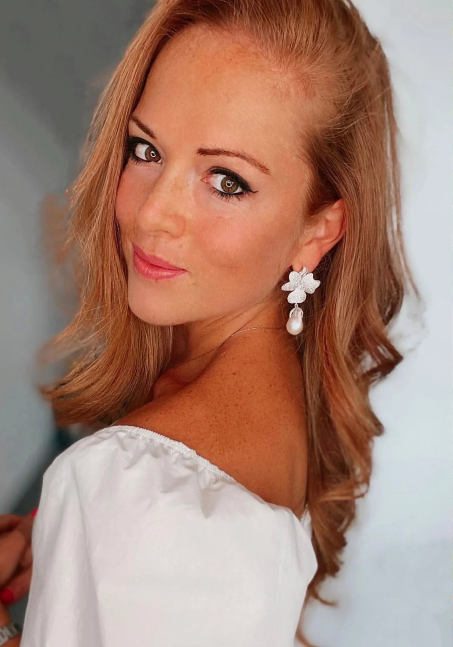 The earring worn by a model.