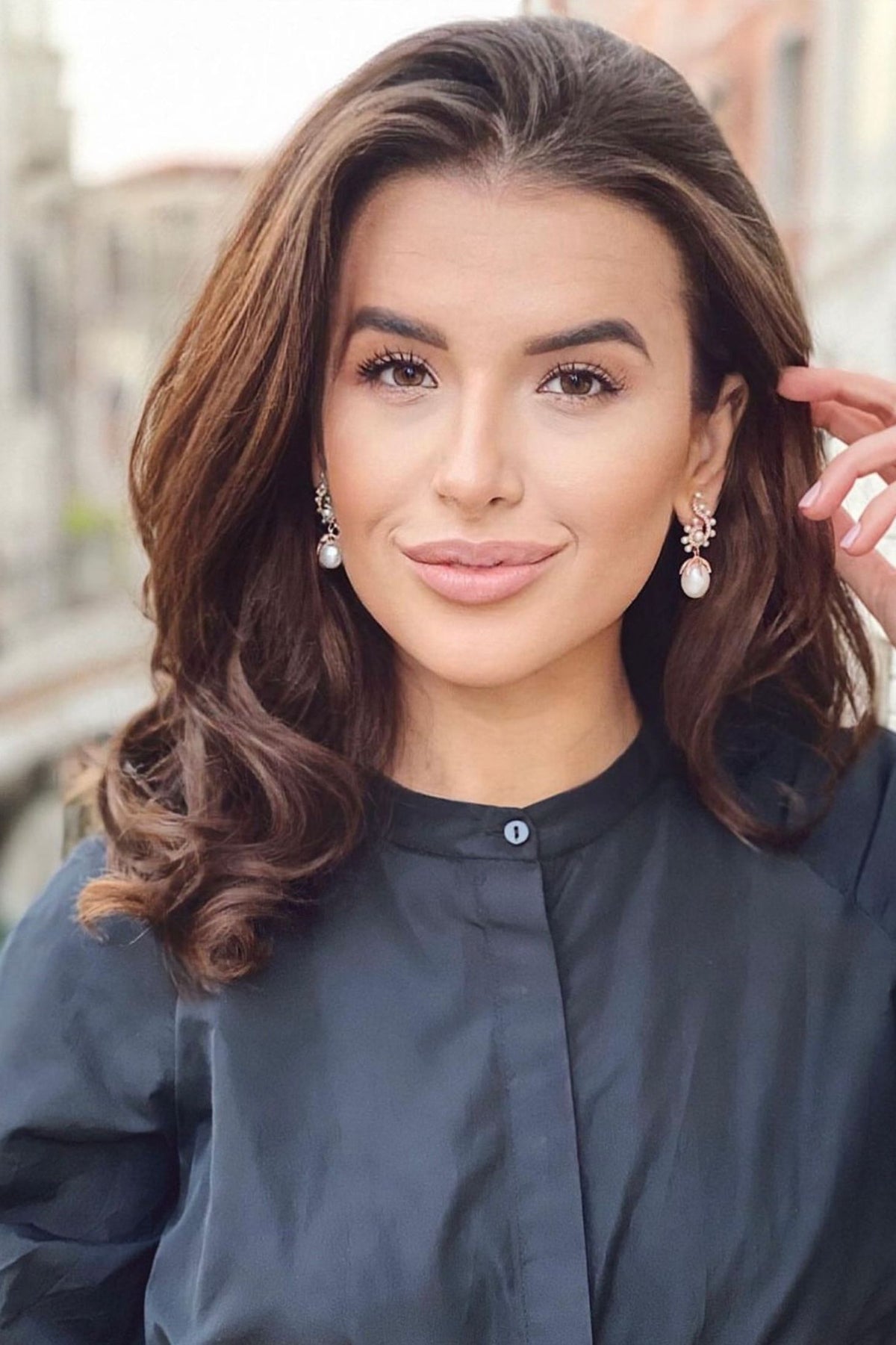 The earring worn by a model.