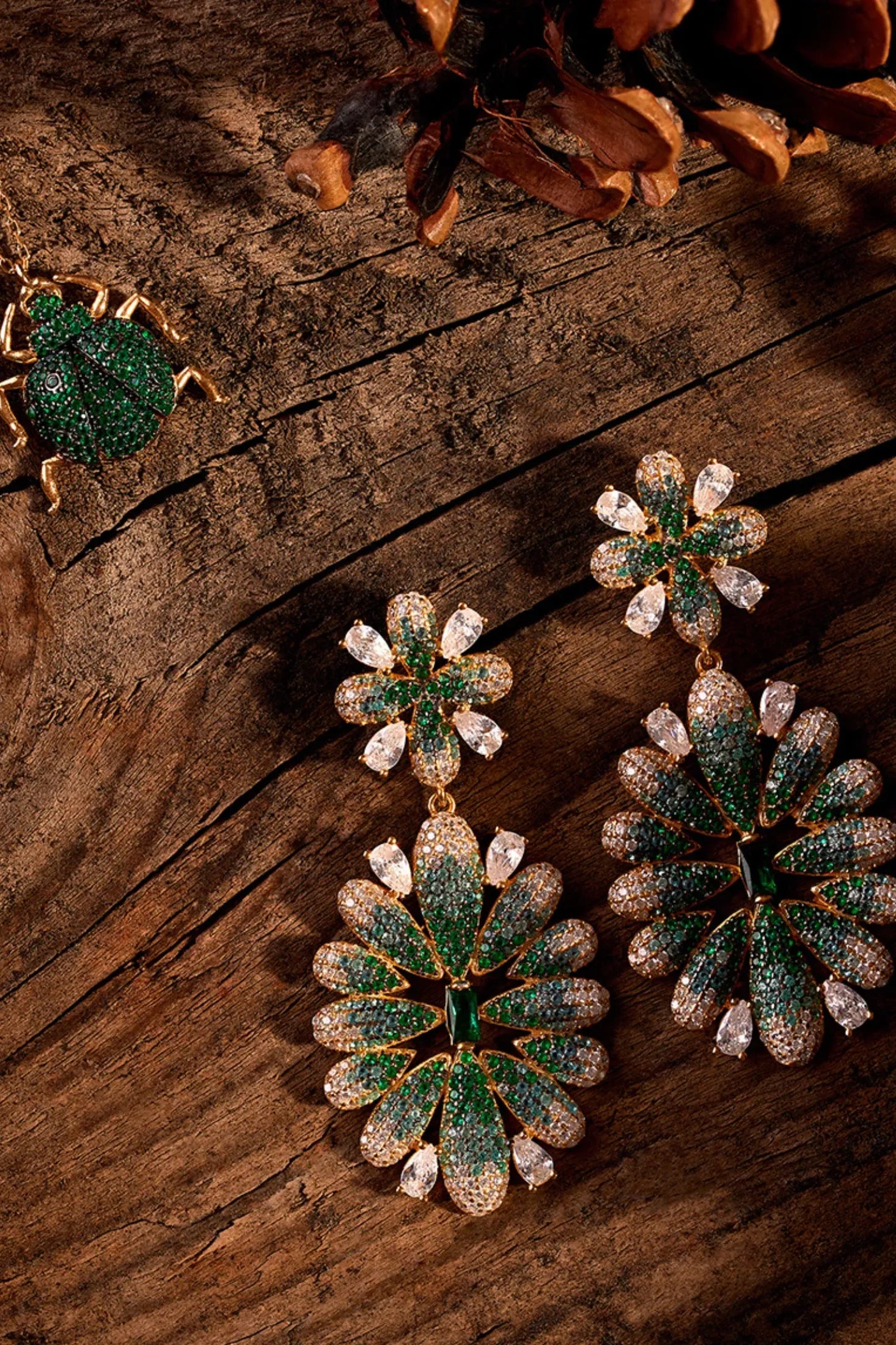 Babylon Flower Drop Earrings Gold Green worn by a model, showing how they sit on the ear and their scale.