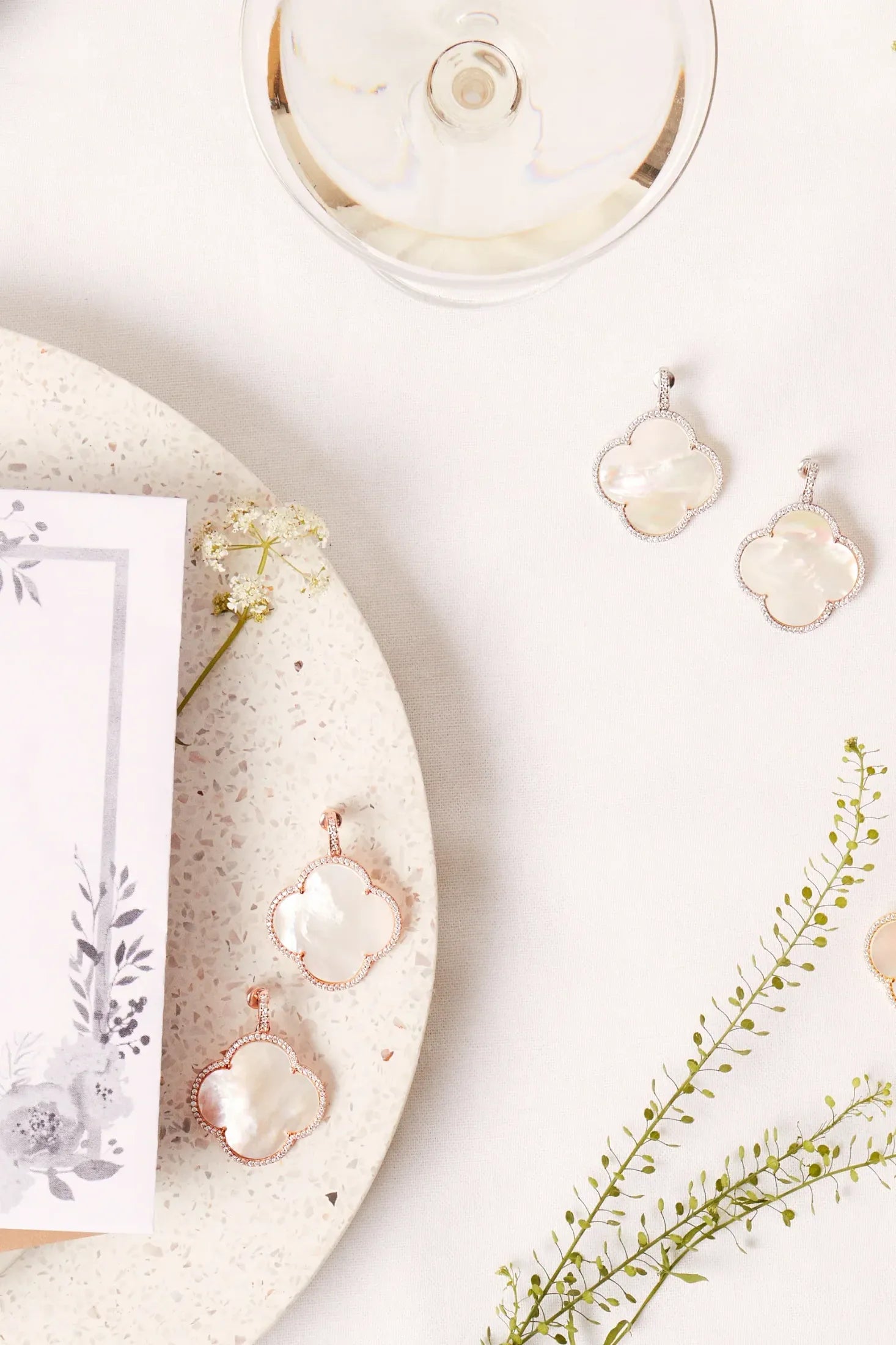 Antoinette Earrings White Mother Of Pearl Rose Gold worn by a model, showing how they sit on the ear and their scale.