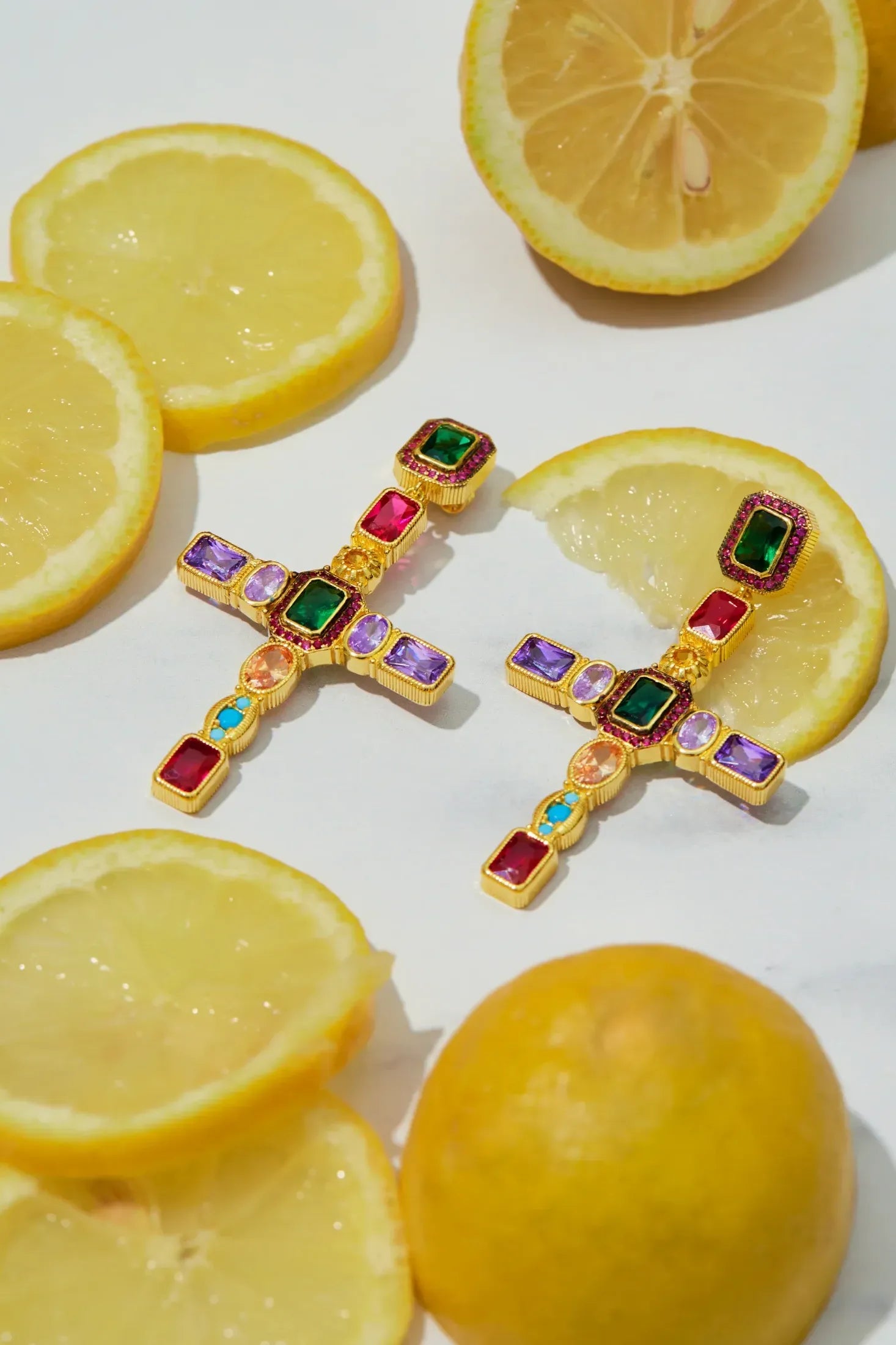 Maria Extra Large Gemstone Fashion Earrings Gold (Cross) worn by a model, showing how they sit on the ear and their scale.