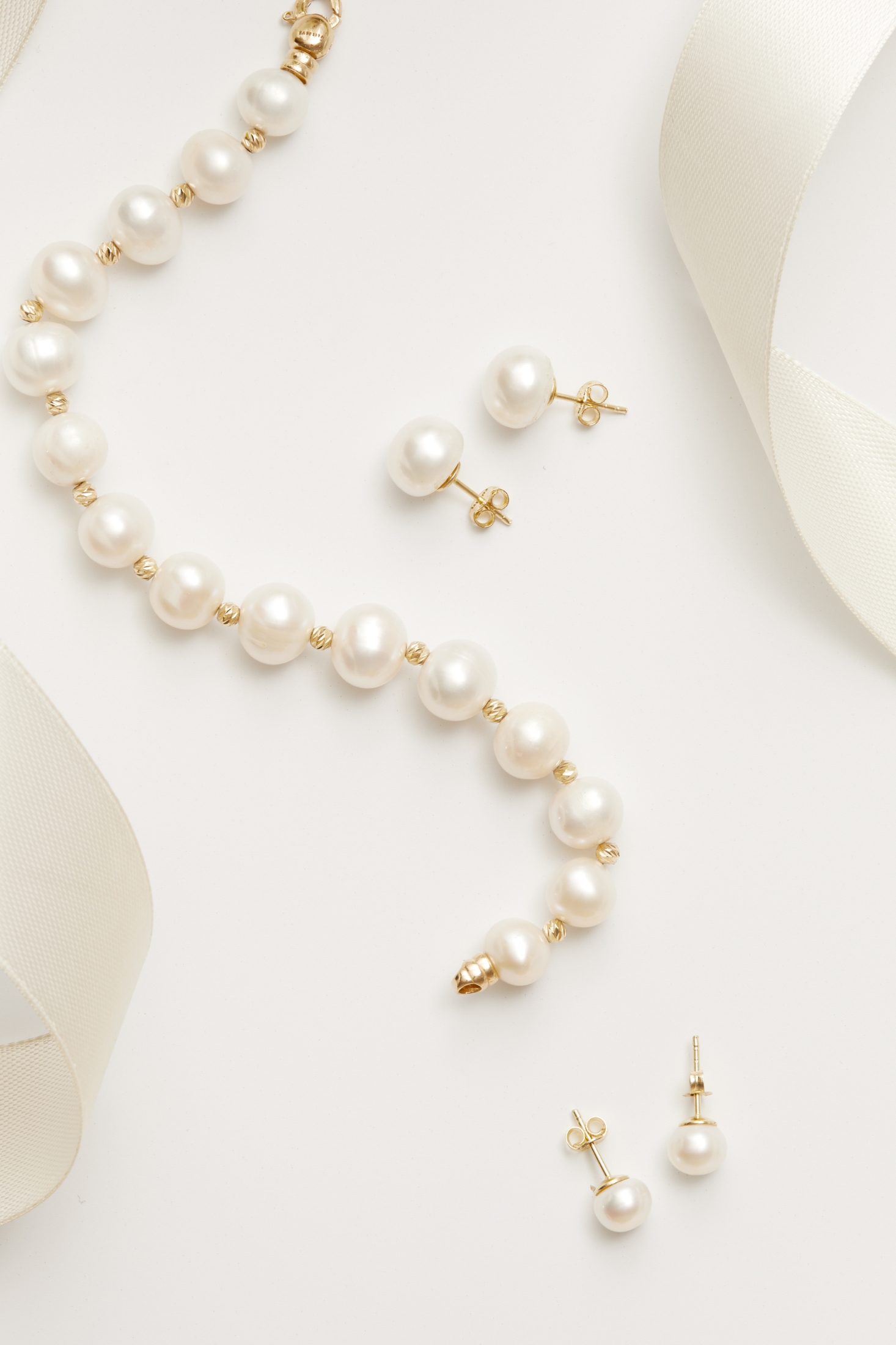 Solid 14K Gold Classic Natural Pearl Bracelet worn by a model, showing how it fits on the wrist and its scale.