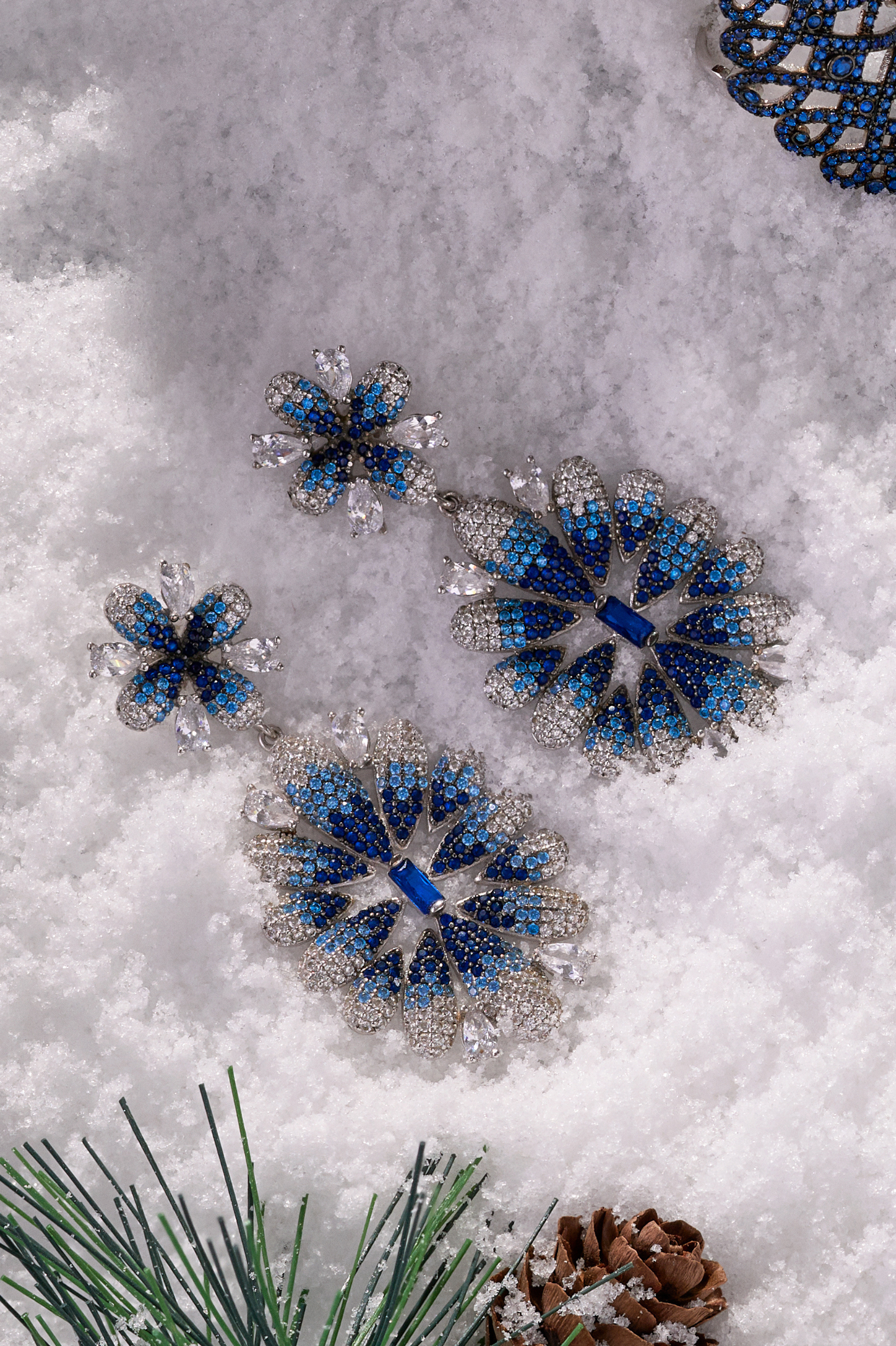 Babylon Ice Blue Gradient Flower Drop Earrings Silver worn by a model, showing how they sit on the ear and their scale.