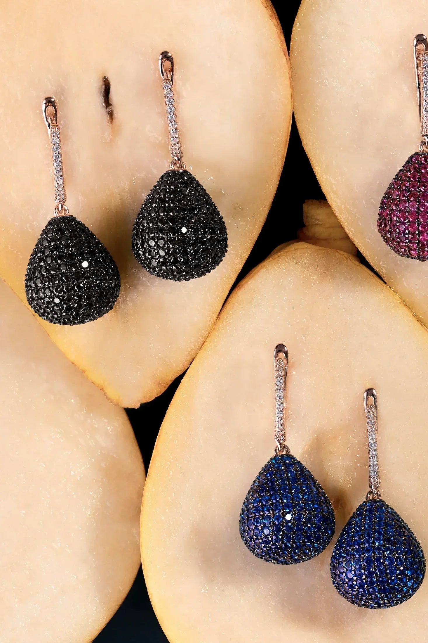 Valerie Pear Drop Gemstone Earring Rose Gold Sapphire Blue worn by a model, showing how they sit on the ear and their scale.