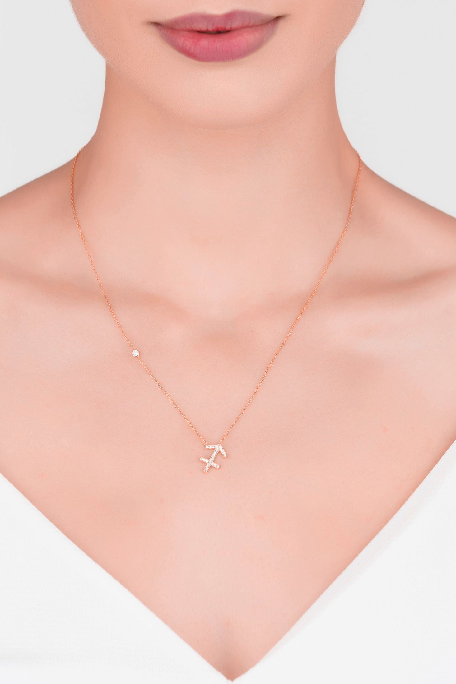 Angled view of Zodiac Star Sign Pendant Necklace Rose Gold Sagittarius, showing star design, rose gold finish and the jewellery profile.