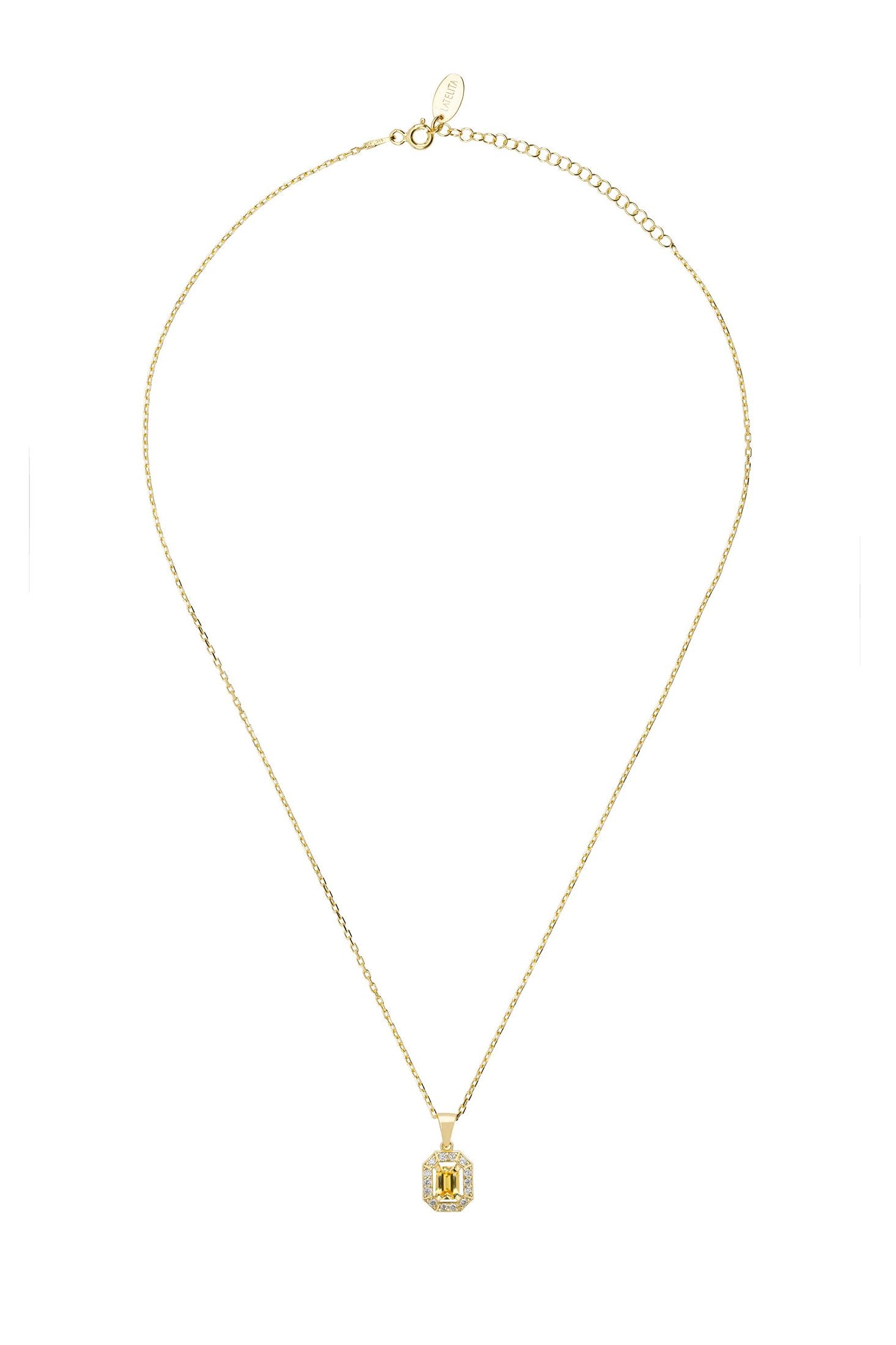 Gold necklace with a green gemstone pendant on a white background