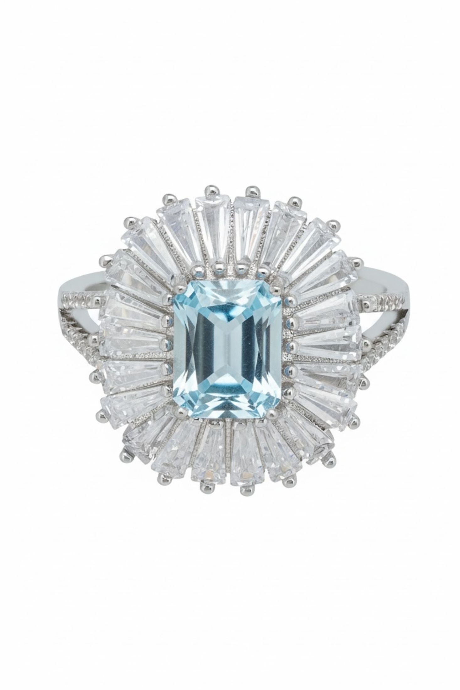 Ring with a central blue gemstone and diamond-studded halo on a white background