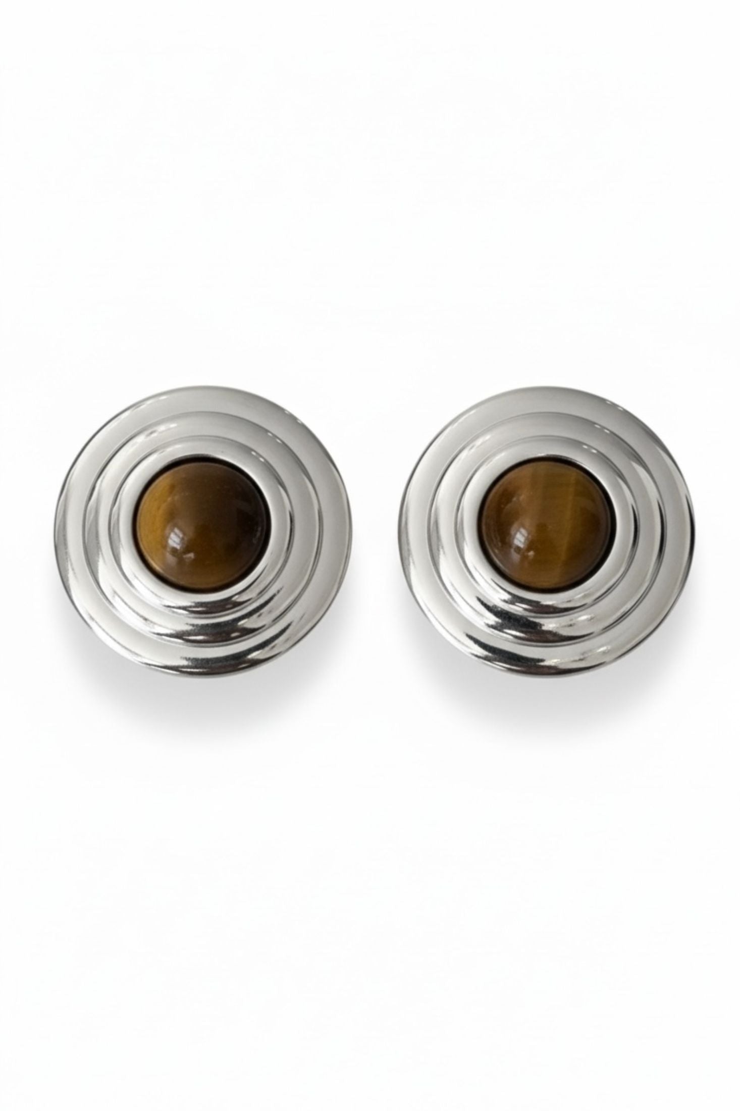 Pair of silver earrings with tigers eye gemstones on a white background