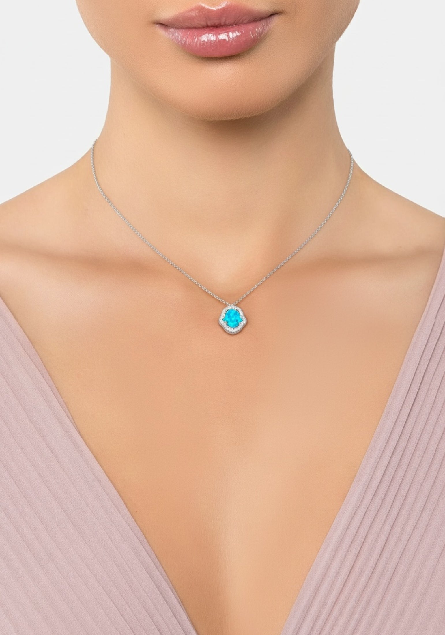 Necklace with a blue pendant worn by a model on a plain background