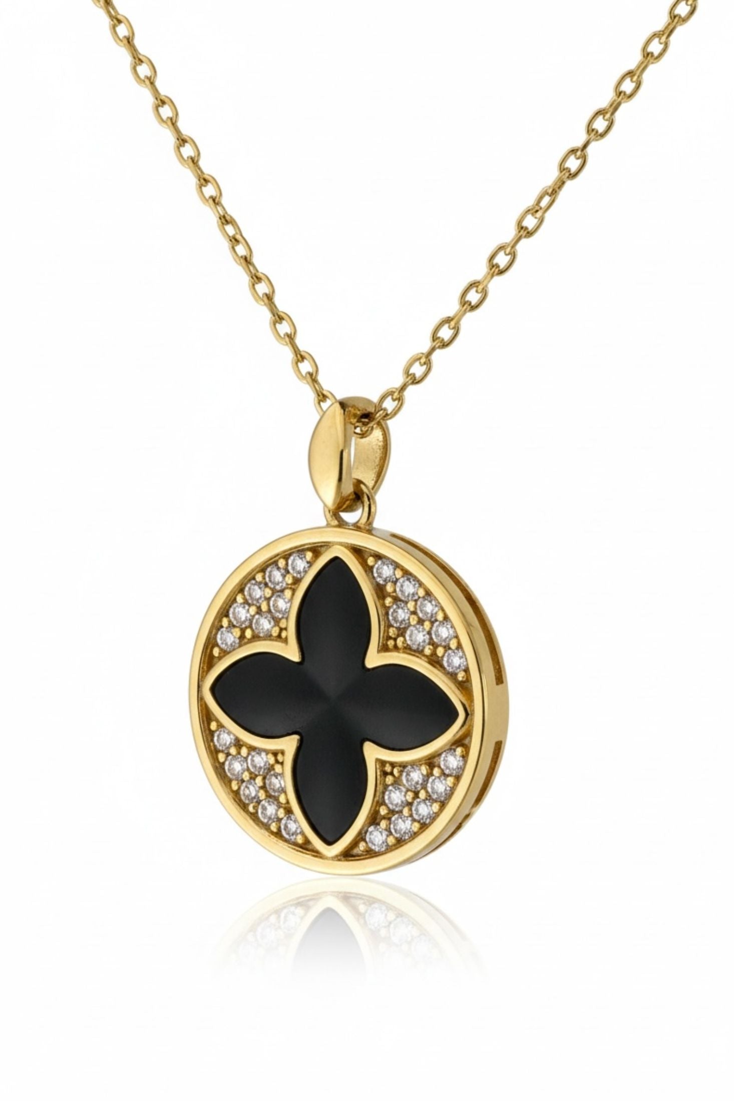 Gold necklace with a black floral pendant on a white background