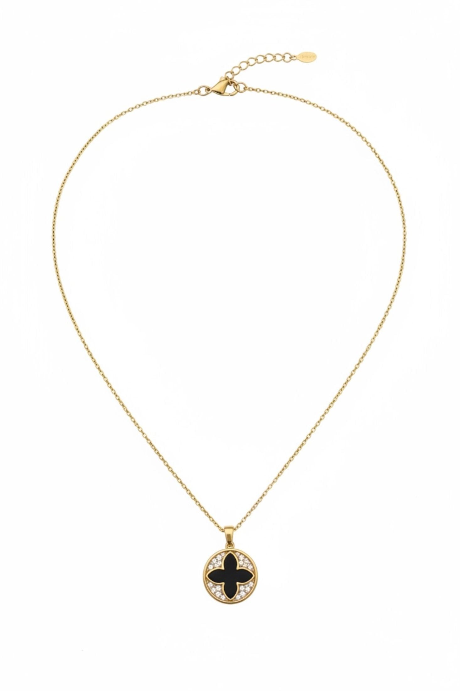 Gold necklace with a black pendant on a white background