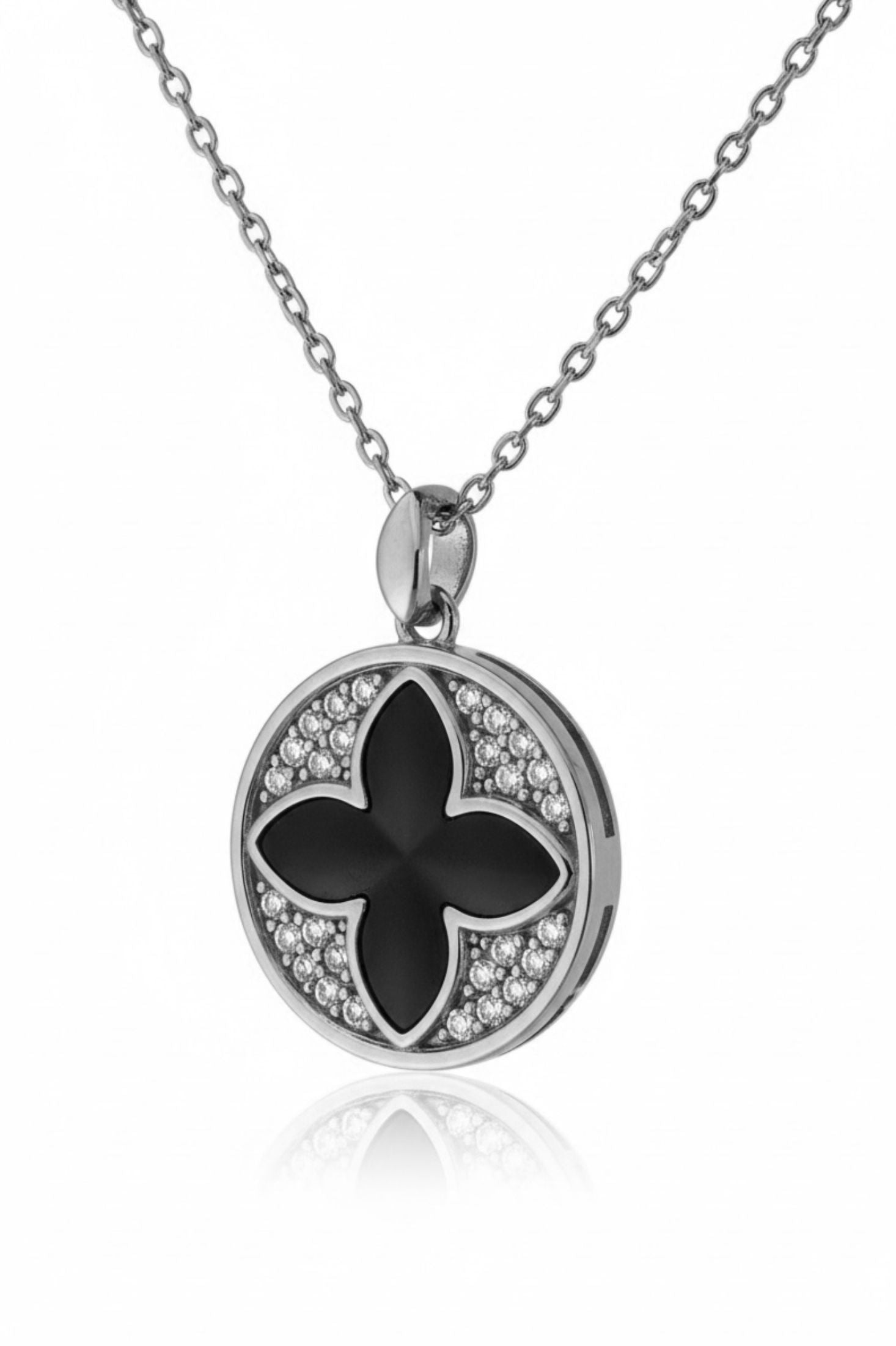 Silver necklace with a black flower pendant on a white background