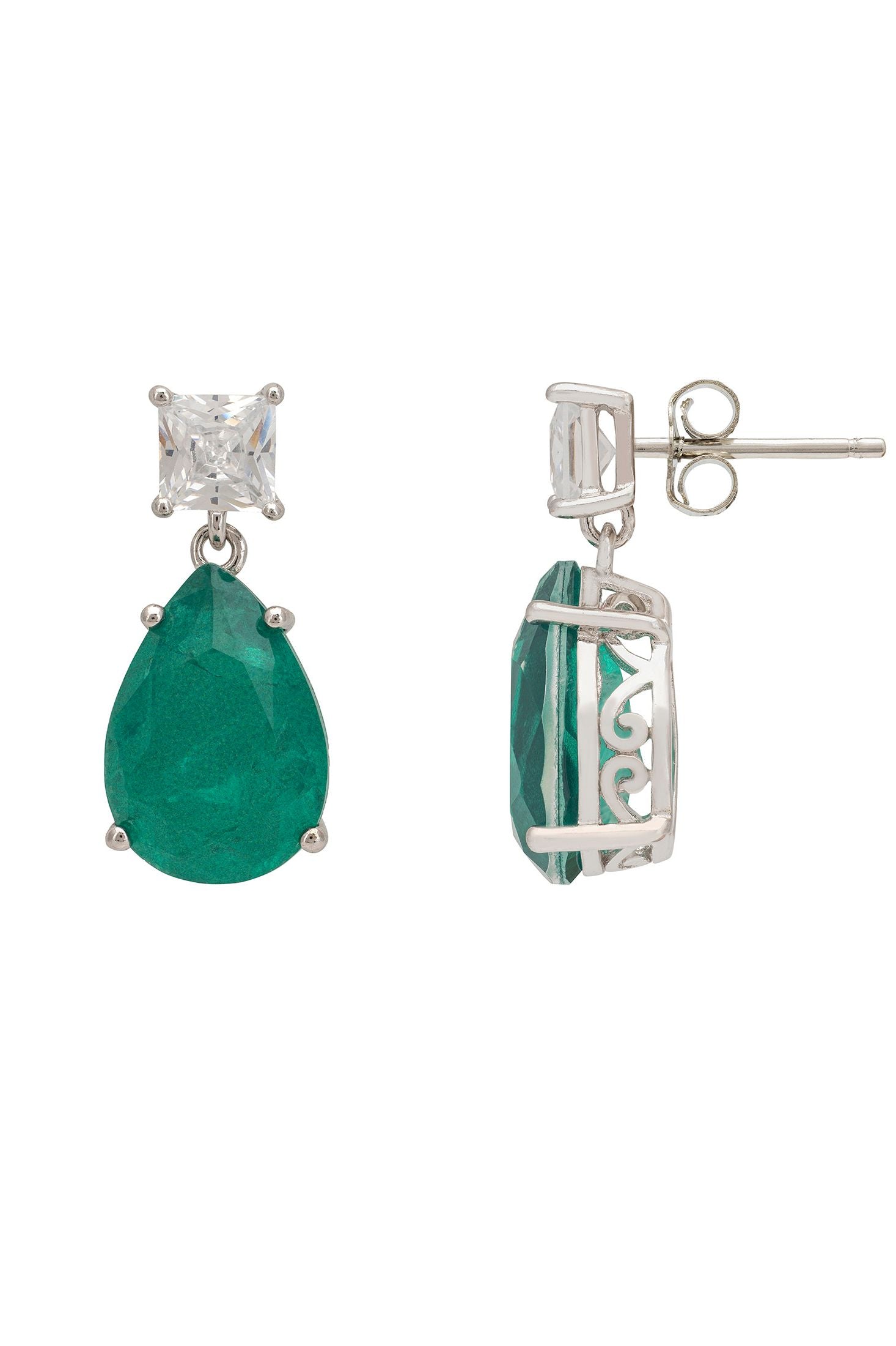 Pair of earrings with green gemstones and silver settings on a white background