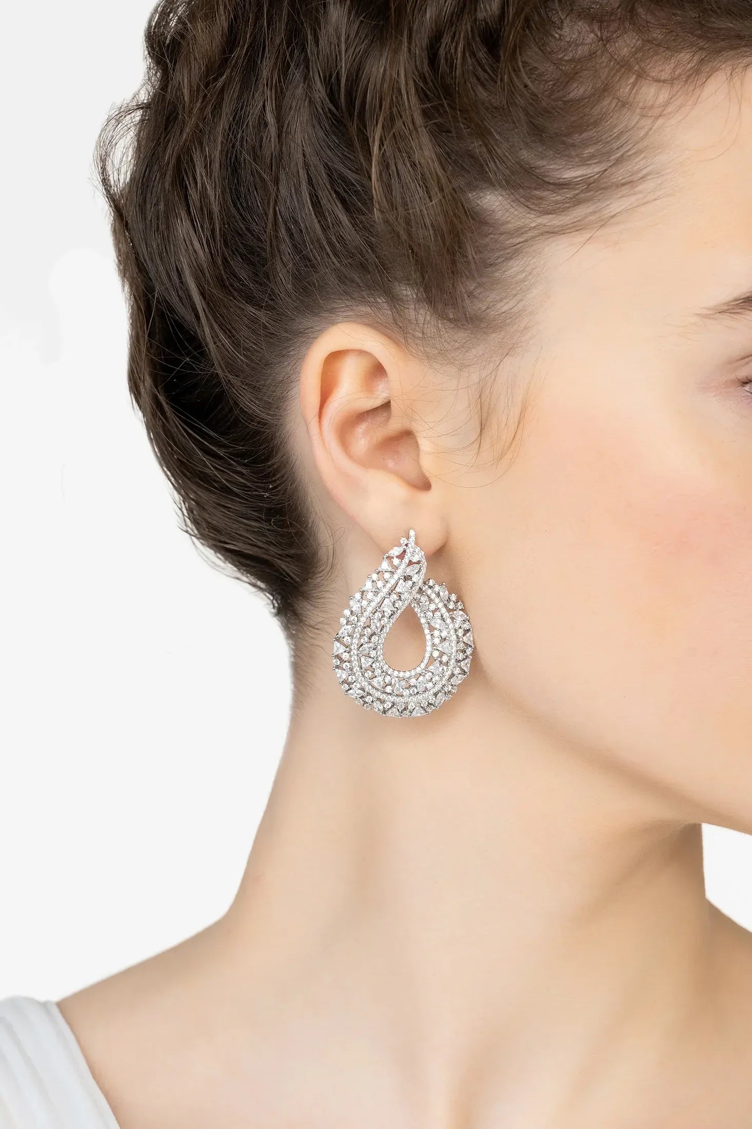 Angled view of Adalinda Sweeping Hoop Earrings Silver, showing silver finish and the jewellery profile.