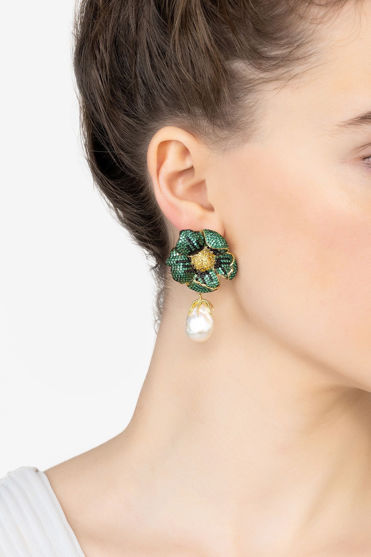 Angled view of Poppy Flower Baroque Pearl Earrings Emerald Green Gold, showing flower design, baroque pearl and pearl detailing, gold finish and the jewellery profile.
