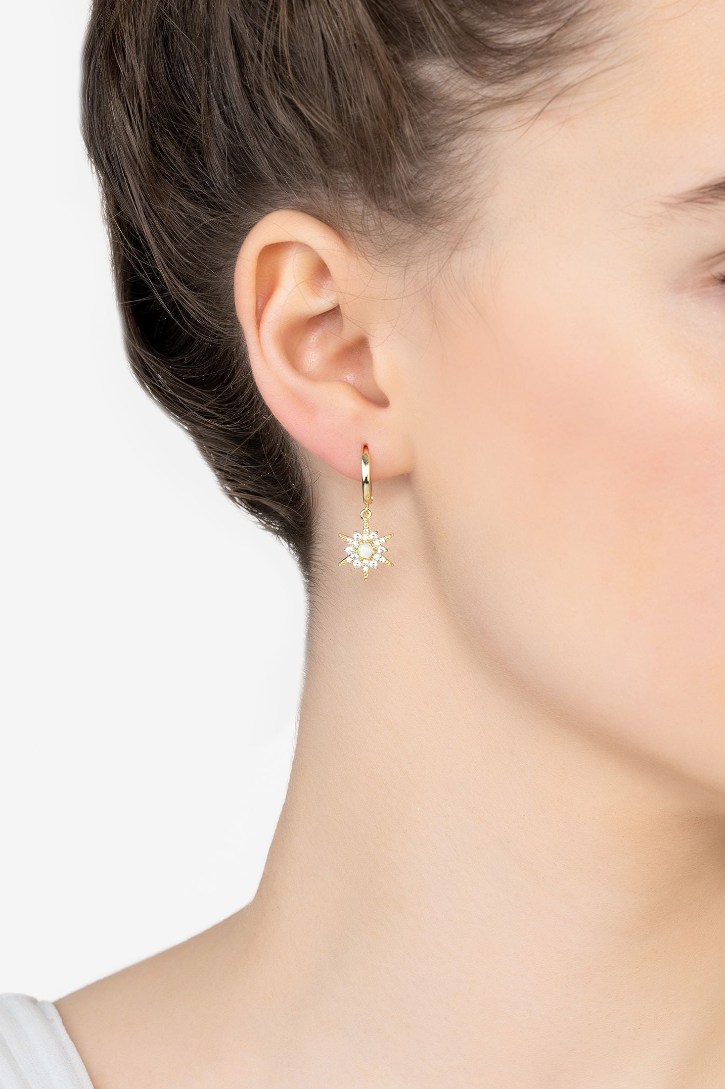Angled view of Opal Starburst Hoop Earrings Gold, showing star design, gold finish and the jewellery profile.