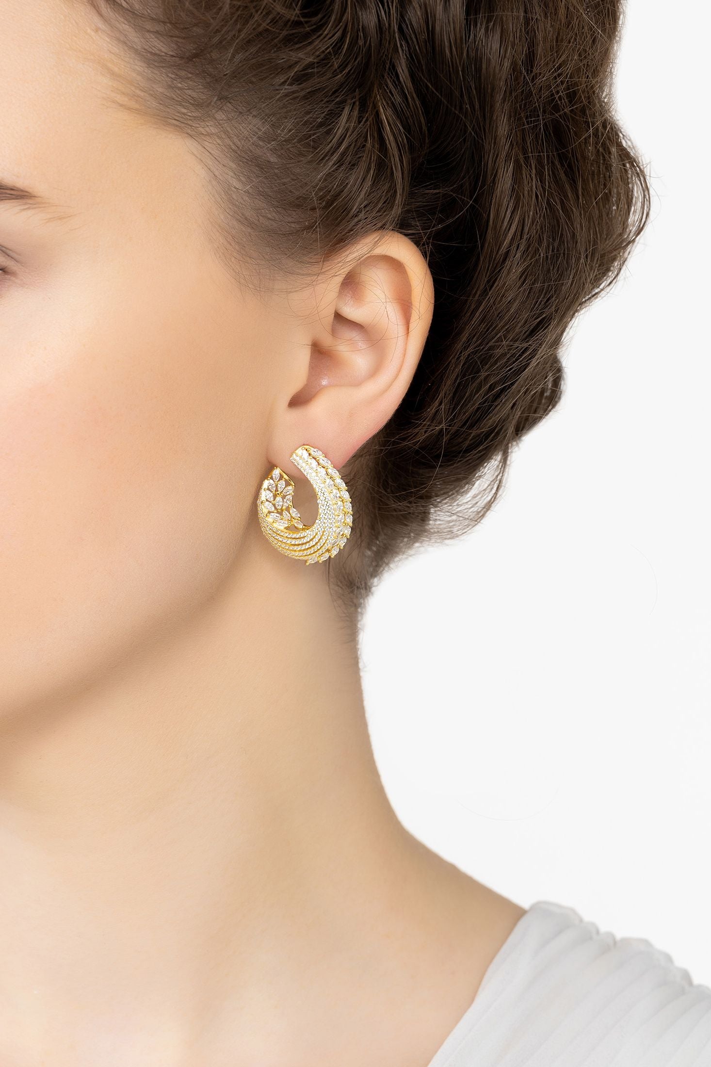 Angled view of Artemis Sweeping Hoop Earrings Gold, showing gold finish and the jewellery profile.